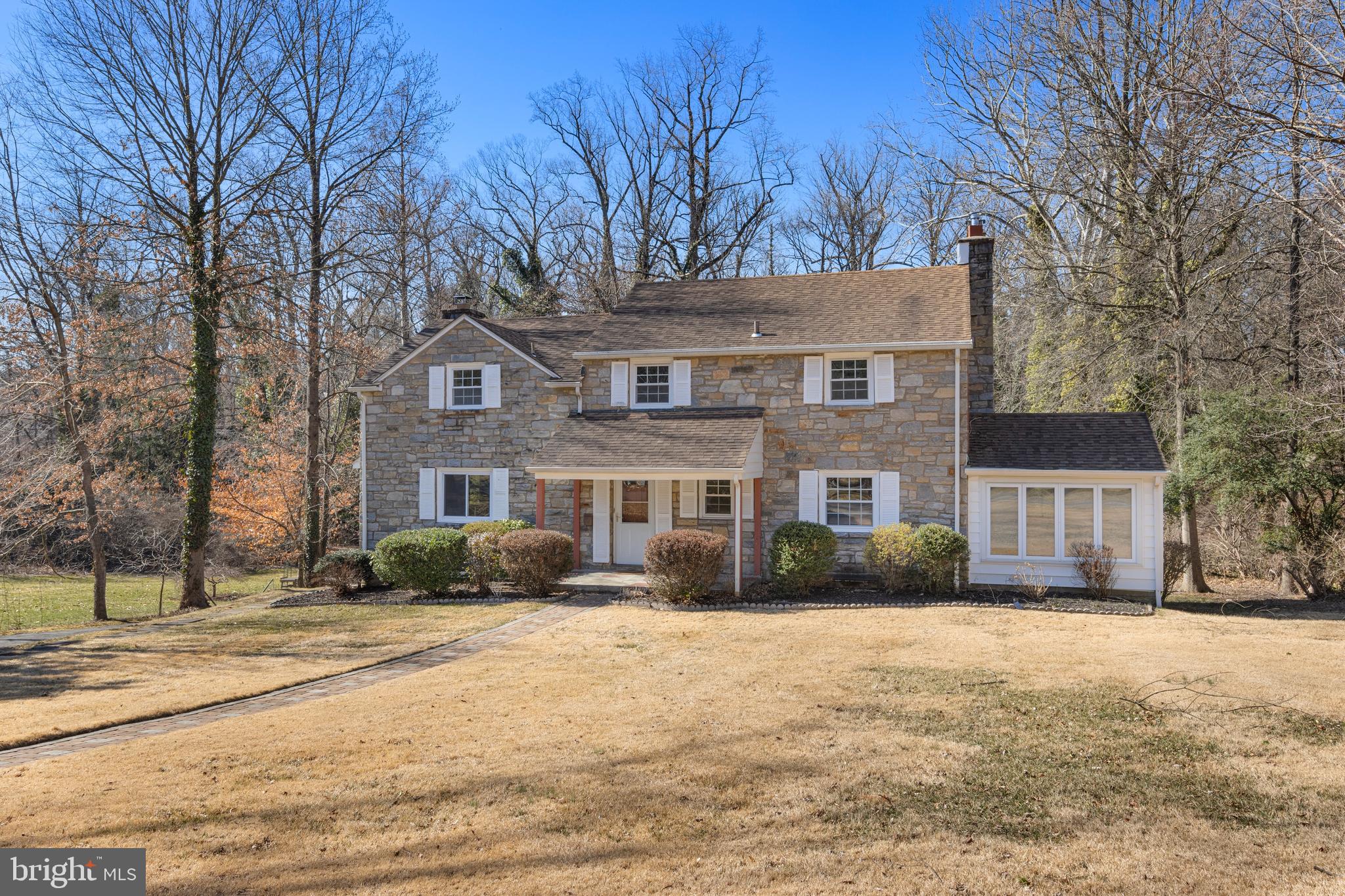 Nestled on a tree-lined street in the sought-after neighborhood of Wallingford Hills, this classic 4 BD, 2/2 BA stone colonial home features gleaming wood floors and is flooded with natural light. The Center Entrance Hall opens to a very large Living Room with a fireplace and a wall of windows overlooking the scenic rear yard. For those seeking work-from-home space, there is also a paneled Study (or cozy Den) with built-ins and a door to the bright Sunroom. The spacious Kitchen has stainless appliances, gas range with exhaust fan, granite counters, and a large breakfast bar – perfect for chatting with guests while cooking your favorite meals. The Kitchen is open to the Dining Room, which has a 2nd fireplace and large windows. A Powder Room and large coat closet complete the main floor. The second floor features a spacious Primary Bedroom with two closets, windows on 3 elevations, and a renovated Primary Bathroom. Three more generously-sized Hall Bedrooms have big closets and share a renovated Hall Bathroom. Downstairs is a sun-drenched, tiled, expansive Family Room with a 3rd fireplace and a wall of windows. This level of the home also has an unfinished Laundry/Utility Room, a 2nd Powder Room, and access to the oversized 2-car Garage. Enjoy outdoor entertaining on the rear paver patio, brisk fall evenings in front of the stone outside fireplace, or cool off in warm weather on the rear deck behind the Sunroom. The sweeping scenic views include woods and a creek, which is on township-owned land behind expansive .33 acre lot. The property "lives" much larger because it backs to open space. The inviting neighborhood has no formal dues, but has a neighborhood directory and events that help foster a close-knit sense of community year-round including neighbohrood happy hours, Oktoberfest, a holiday party, trick-or-treating, and more. Award-winning Wallingford Swarthmore school district with Wallingford Elementary School, Furness Park and the Wallingford SEPTA train station all within walking distance. The Leiper-Smedley Trail, Helen Kate Furness Free Library, and the Community Art Center are all nearby too! Easy access to Center City, Wilmington, I-95, the Blue Route, and the Airport.