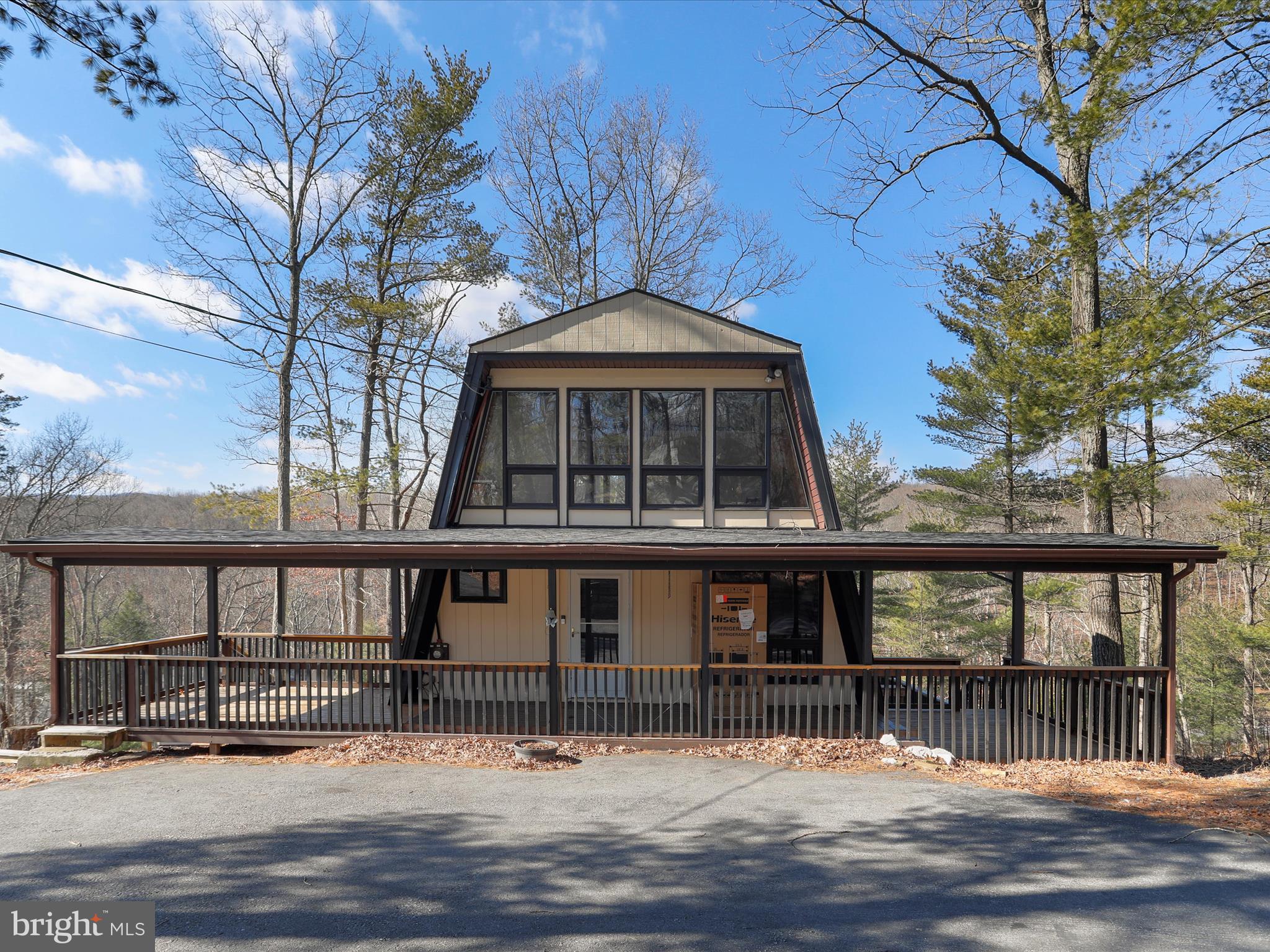 Welcome to 85 Audubon Road, an inviting blend of rustic charm and modern comfort, perfect for those seeking a permanent or weekend residence in a tranquil, lakeside setting. Nestled on a spacious 1.21-acre lot in the desirable Sleepy Hollow subdivision, this 4-bedroom, 3-bath cabin-style home offers 195 feet of private lake frontage and breathtaking views—now exclusively available for full-time homeowners, as recent HOA updates no longer permit short-term rentals.
Inside, you’ll find warm wood floors and a cozy, welcoming atmosphere. The renovated kitchen features granite countertops, a stylish tile backsplash, and ample space for meal prep and hosting family or friends. The main-level primary suite offers beautiful wood flooring and a peaceful retreat at the end of each day.
Spend evenings by the wood stove in the living room or step outside onto the expansive wrap-around deck to take in the sights and sounds of nature. Whether enjoying quiet mornings by the lake or entertaining guests, the outdoor space is truly a highlight.
Located just 4 miles from The Woods Resort Golf Course and its dining and spa amenities, this home provides the perfect balance of seclusion and convenience. With plenty of outdoor space, serene lake views, and a community focused on full-time living, 85 Audubon Rd offers a rare opportunity to settle into your forever home by the water.
Schedule your private tour today and experience lakeside living at its best.