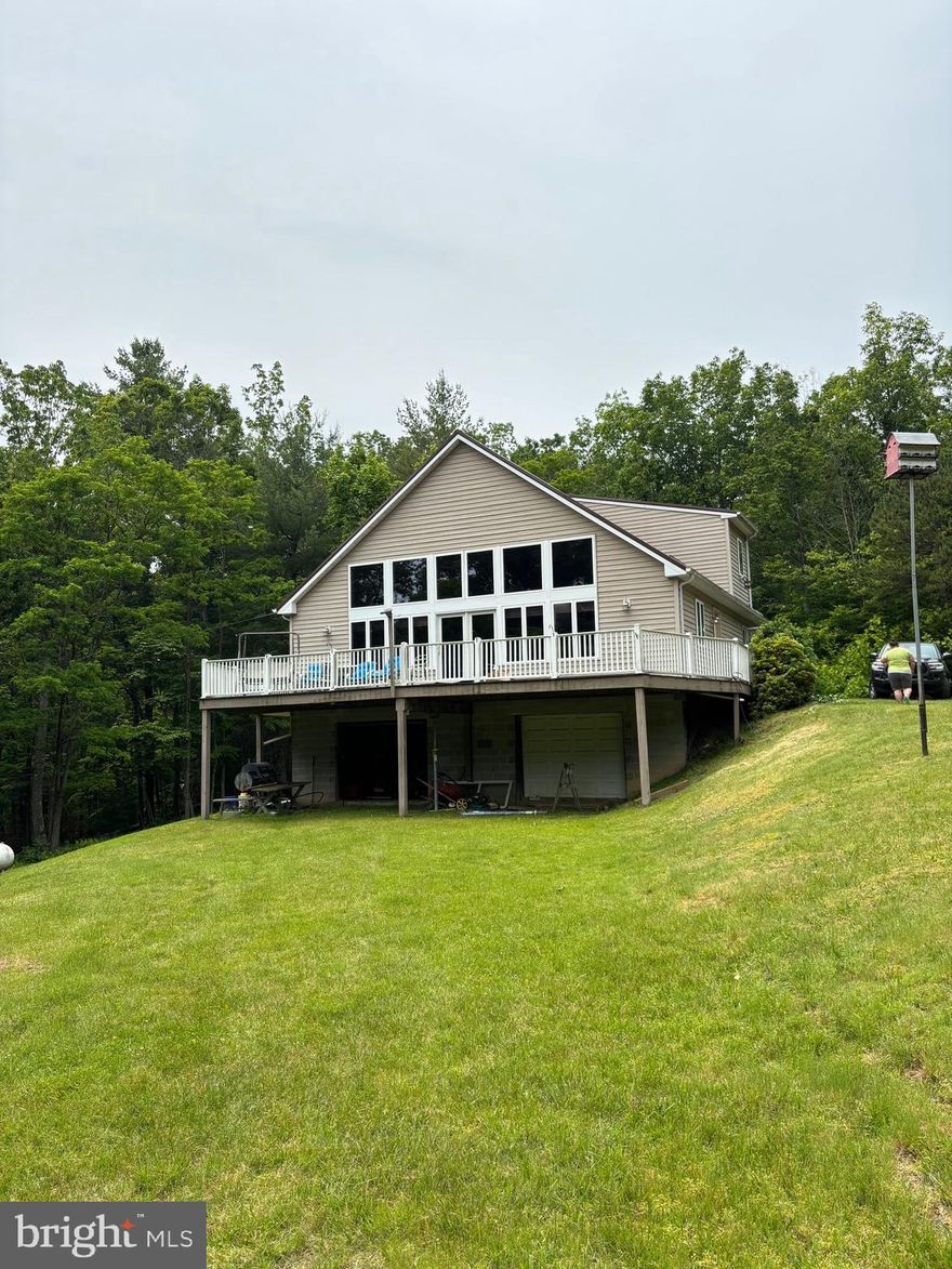 Charming Woodland Retreat on 42.62 Acres in Treasure Mountain Estates

Nestled in the heart of Treasure Mountain Estates, this beautiful three-bedroom, 2 bath home sits on 42.62 acres of pristine woodland, offering the perfect blend of comfort and seclusion. The inviting interior features stunning wood walls and ceilings, a bright and airy living room with abundant natural light, and a spacious kitchen with island ideal for gathering and entertaining. One of the bathrooms showcases a unique, handcrafted penny countertop, adding rustic charm and creativity. The home is efficiently heated by wood, oil, or electric, and includes air conditioning and a Generac whole-house generator for peace of mind. Step outside to enjoy a gently rolling yard, established orchard, pond, and a large workshop—perfect for vehicle projects or extra storage. Whether you're seeking a private residence or a weekend retreat, this property is a rare find.