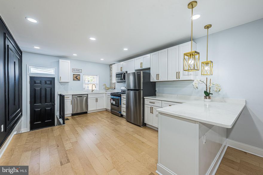 CUTTING EDGE RENOVATION WITH 3 FINISHED LEVELS OF DESIGNER LIVING SPACE! Open floor plan featuring wood floors throughout, uniquely designed accent walls, a gourmet kitchen with Quartz counters & ss appliances, upper level Primary bedroom suite with a full bath, 2nd bedroom with a hall bath, finished basement with a family room, 3rd bedroom, & 3rd full bath, and a private rear deck and patio! Located steps from the MARC Train station and a quick commute to downtown Baltimore! Pack your bags and move right in!