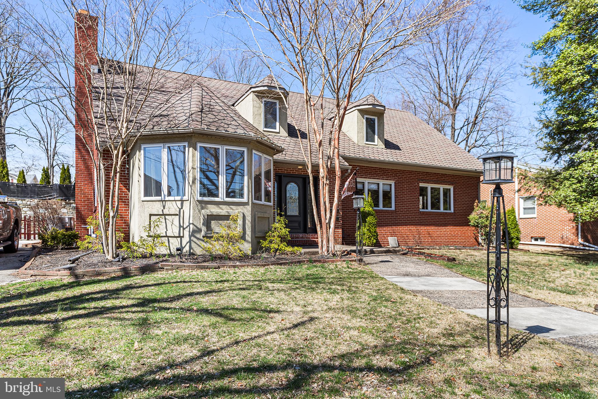 This spacious corner property presents a rare opportunity to own a single-family home in Springfield, just a short walk from the vibrant shops and restaurants on Saxer Ave, as well as schools, the library, and the playground at William’s Park with a true in-law unit. A standout feature of this property is two complete and separate dwellings, offering privacy and versatility. The main house, a 3-bedroom, 1.5-bathroom home, features newly refinished hardwood floors throughout and an inviting, bright atmosphere. The modern kitchen is a true highlight, featuring a large center island, built-in seating, and plenty of storage. The expansive Jack and Jill bathroom offers direct entry to the primary bedroom, adding convenience and privacy. The two additional bedrooms are generously sized, providing ample storage and comfortable living space. The in-law unit can be accessed from the interior of the home but also has its own exterior staircase providing a multitude of options for how the new owners can make this property their own. This bright and sunny additional space offers an open-concept living area with wood burning fireplace, an updated kitchen with stainless steel appliances, a cathedral ceiling sunroom and two spacious bedrooms that share a full bathroom, perfect for extended family or guests. Each floor has separate utilities as well as laundry. The property also includes a two-car garage, a small grass area, and a wraparound driveway, completing this fantastic and versatile home. Whether you're looking for extra space or multi-generational living, this property has it all.