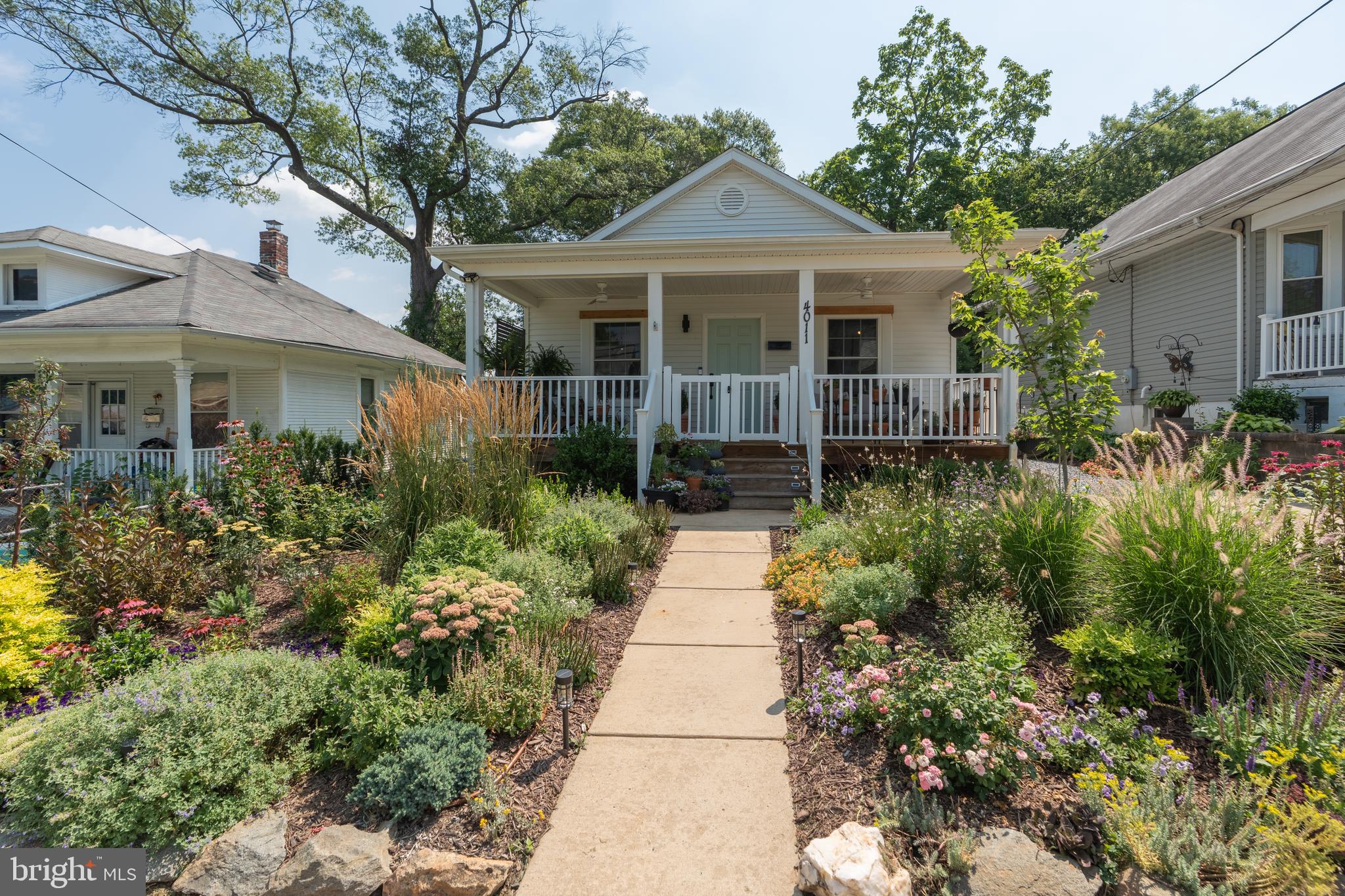 Tucked into one of the most charming pockets of historic Mount Rainier, this modern bungalow blends comfort, efficiency, and style in all the right ways. Built in 2016 and thoughtfully updated since, the home features a smart, well-proportioned layout that makes the most of every square foot. Inside, you'll find bright, open living spaces, two comfortable bedrooms, and a kitchen with clean, modern finishes—all designed for easy everyday living without sacrificing character.
Recent upgrades include a brand new HVAC system (2025), new water heater (2025), all new appliances (2025), and a fully fenced-in yard—ready for pets, gardening, or quiet afternoons outdoors. Out back, you'll find a solar-powered shed offering flexible space for storage, projects, or even a small studio setup.
The unfinished basement, a rare bonus in a home this size, provides even more room for storage or future customization.
The garden is a lush, layered mix of cottage-style plantings that bloom across the seasons. Thoughtfully designed and on drip irrigation, the entire yard can be watered right from your phone—making it as low-maintenance as it is beautiful. The inviting front porch offers the perfect perch to enjoy it all, whether you're sipping morning coffee or winding down with a glass of wine as neighbors stroll by. It’s a peaceful, lived-in space that feels like an extension of the home.
While the garden adds undeniable charm to the property, it’s the thoughtful updates and easy functionality that make this home truly stand out. Located just minutes from DC and close to local favorites in Mount Rainier and Hyattsville, this is a smart and stylish option for anyone looking to put down roots in one of the area's most vibrant, connected communities. Agent is owner.