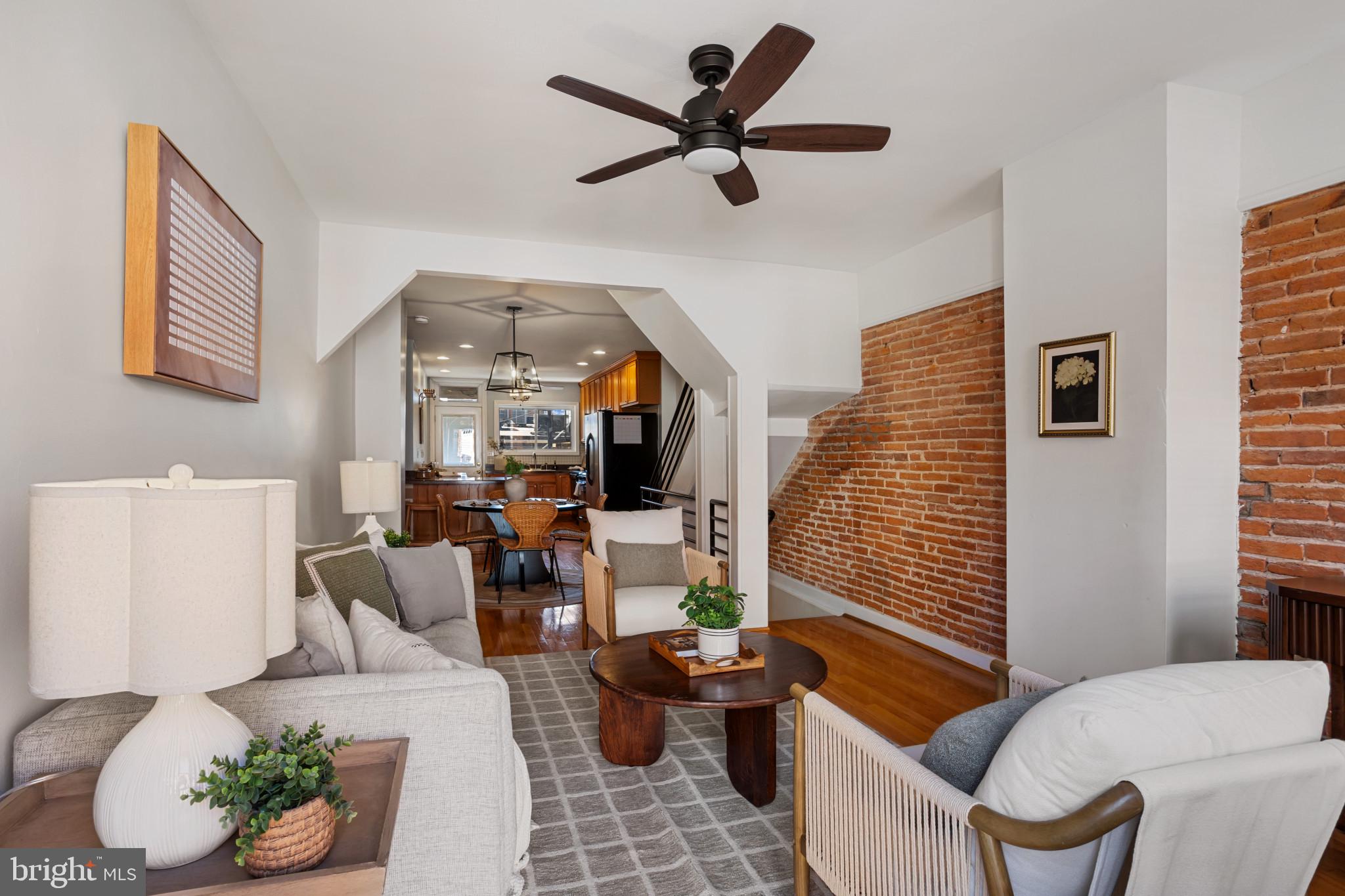 Welcome to 1236 Wall St, a beautifully updated three-bedroom, two-bathroom rowhome in the heart of Federal Hill. This home features gleaming hardwood floors, exposed brick, and recessed lighting throughout. The open main level includes a spacious living and dining area leading to a renovated kitchen with over 12 feet of countertops, shaker cabinets, and stainless steel appliances. Upstairs, the primary bedroom boasts ample closet space, while a second large bedroom and updated full bathroom complete the level. Enjoy stunning city views from the new 2nd floor and rooftop deck. The finished lower level provides additional living space, perfect for a media room or gym and a full bath. Recent updates include a new roof (2024), new bi-level deck (2024), and certified Lead Free. Steps from restaurants, shops, parks, and the Inner Harbor, this move-in-ready home is a must-see!