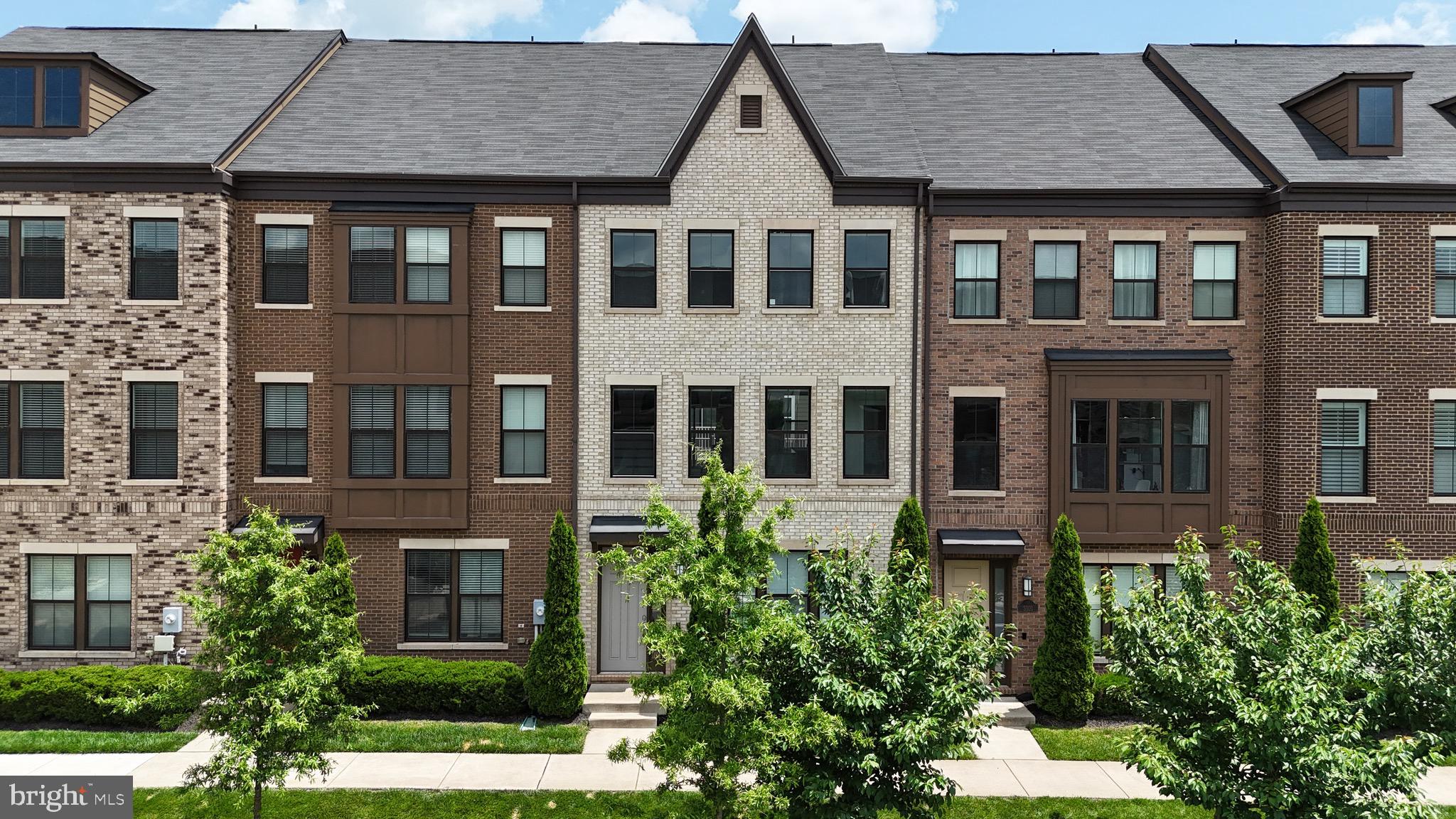 Welcome to 3099 Alan Shepard Street, a luxurious 4-level townhome located in the highly sought-after Discovery Square community in Herndon. This contemporary residence offers over 2,600 square feet of thoughtfully designed living space, highlighted by a spectacular rooftop terrace, perfect for outdoor entertaining or peaceful retreats. The top level features a large loft with a half bath, easily convertible into a fourth bedroom or guest suite. The main level boasts an open-concept layout with an exquisite gourmet kitchen, complete with upgraded appliances, a stunning waterfall island, wine storage, and abundant natural light flowing into the spacious dining and family room. A convenient half bath is also located on this level. The upper level offers three generously sized bedrooms and two full baths, including a spacious primary suite with a large walk-in closet and a spa-like bathroom. The entry level includes a full bath and a versatile recreation room or guest space, ideal for a home office or in-law suite. Additional features include an attached two-car rear-entry garage, modern finishes throughout, crown molding, a cozy gas fireplace, and stylish lighting.
Situated just off Route 28, this location provides unbeatable access to Dulles Airport, the Dulles Toll Road, Route 50, and I-66. It is also adjacent to the Dulles Discovery campus and just minutes from the Innovation Center Metro Station, Reston Town Center, Worldgate Centre, and Dulles Town Center Mall. Whether commuting to nearby tech hubs or exploring the vibrant Northern Virginia corridor, this home puts everything within reach. Discovery Square is a professionally managed community that offers tot lots, playgrounds, and included services such as front yard lawn care, snow removal, and trash collection, making for easy, low-maintenance living. Don’t miss this rare opportunity to own a beautifully upgraded home in one of Herndon’s most connected and convenient locations.