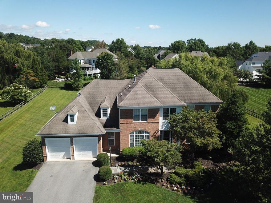 PRICE IMPROVED! OFFER DEADLINE 8/4 5 PM.  Welcome to this exquisite single-family home, beautifully constructed by Mitchell & Best, nestled in the highly sought-after Potomac Glen community. Boasting 5,241 square feet of refined living space, this residence features 5 bedrooms, 4.5 bathrooms, and a two-car garage, all set on the largest lot in the community—1.1 private acres.

This home has been freshly painted and features refinished hardwood floors, resurfaced kitchen cabinets, a new front door, new electric cooktop, and motion-sensor range hood. Most kitchen appliances, the washer, and garage door opener are less than 2 years old. Classic architectural charm blends with abundant natural light to create a warm, inviting atmosphere throughout.

Thoughtful Upgrades & Outdoor Features
A unique upgrade includes dual water meters, with one dedicated for outdoor use—ideal for gardeners or future landscaping plans. The irrigation system features 12 programmable zones, allowing customized watering for lawns and flower beds.

Step outside to enjoy a 500-square-foot deck with a pergola, perfect for morning coffee, outdoor dining, or entertaining. The deck connects seamlessly to a stone patio and the expansive fenced backyard below.

Elegant Interiors
Enter through a grand two-story foyer into a flowing main level filled with gleaming hardwood floors. The gourmet kitchen is a chef’s dream, showcasing granite countertops, a center island, a butler’s pantry, and updated appliances. The kitchen currently features an electric cooktop.

Adjacent to the kitchen is a sunlit family room with large windows, and a stone gas fireplace, providing the perfect space for both relaxation and entertainment. A dedicated home office on the main floor offers a quiet, light-filled space ideal for remote work.

Private Upper Level
Upstairs, you'll find four spacious bedrooms and three full bathrooms, including a luxurious primary suite with a walk-in closet, two additional closets, and a cedar chest. The primary bathroom includes a soaking tub, walk-in shower, and double vanities. A nursery or sitting room is conveniently connected to the primary suite—perfect for growing families.

Fully Finished Walkout Basement
The expansive walkout lower level features a fifth bedroom, a full bath, a bonus room ideal for a home gym, media room, or playroom, and generous storage space.

Prime Community Location
Residents of Potomac Glen enjoy exclusive access to community amenities, including a heated swimming pool, tennis and pickleball courts, basketball courts, and a clubhouse. This home is ideally located near major commuting routes, and a wealth of shopping, dining, and entertainment options.  Churchill School Cluster: Wayside Elementary School, Hoover Middle School and Churchill High School

Don’t miss this rare opportunity to own a beautifully appointed home on a premier lot in one of Potomac’s most desirable neighborhoods.