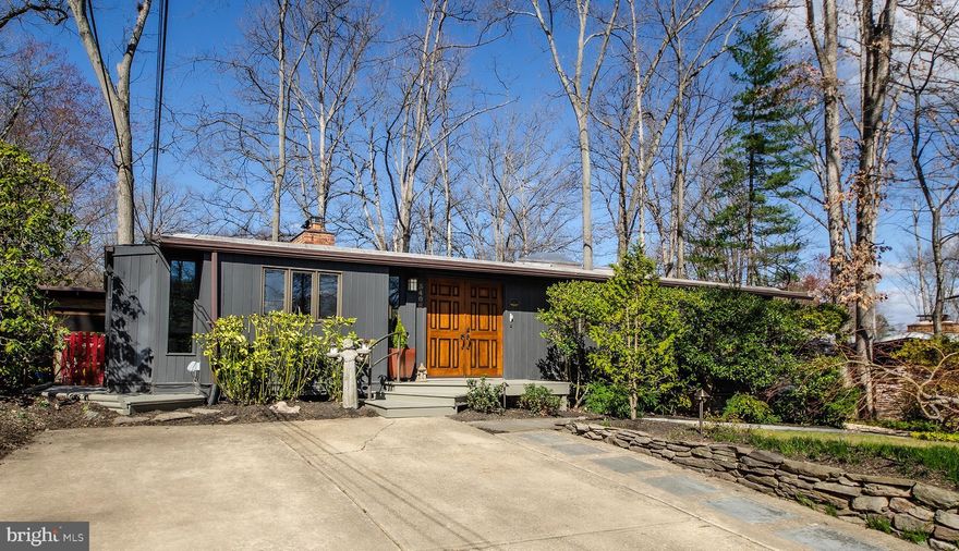 Calling All Mid-Century Modern Enthusiasts! This 2,550 sq ft home is sure to impress-thoughtfully expanded to offer modern amenities and additional living space while preserving the architectural integrity and open  aesthetic that make Mid-Century Modern homes so beloved by design purists. This expanded Luria model is nestled on a sprawling 10,727 sq ft lot, full of mature landscaping providing exceptional privacy and natural beauty. Situated in an extraordinarily serene and peaceful locale within the Holmes Run Acres neighborhood, this special home is just a 1 ½ block stroll from the beloved Luria Park and the vast adjoining Holmes Run Stream Valley Park, woodlands and nature trails.  Step in through the handsome wood double entry doors into a welcoming ceramic tile foyer, where glimpses of the stunning interior unfolds. The “Top Chef” worthy gourmet kitchen w/adjoining dining room addition has been seamlessly integrated, flowing into the reconfigured main level and outdoor living areas.  At the heart of the home, the iconic vaulted family room showcases signature Mid-Century Modern features such as stunning cedar beamed ceilings, warm exposed brick, a cozy wood burning stove, gleaming hardwoods, floating staircase, and a sweeping wall of windows. This thoughtfully designed home offers 4 bedrooms, 2 updated baths and oversized windows, all framed by extensive decking for uncomplicated indoor/outdoor living. The reimagined floor plan also includes a flexible bedroom configuration allowing for handy office, guest room or den options, perfect for today’s work from home lifestyle. The fully finished lower level provides a walkout rec room bathed in natural light, additional bedroom or office options, and abundant storage. Outside, the lush landscaping is complemented by a tranquil screened-in gazebo, relaxing patio, and terraced decking, all overlooking years of carefully curated gardens. The nearby Holmes Run Recreation Association offers 3 sparkling pools in a park-like setting complete with picnic areas, grills and a myriad of recreational activities. Enjoy the perfect blend of serenity and convenience with easy access to major transportation routes, I-495, and the vibrant Mosaic District. Come see why this commuter-friendly enclave is so popular with today’s homebuyers!