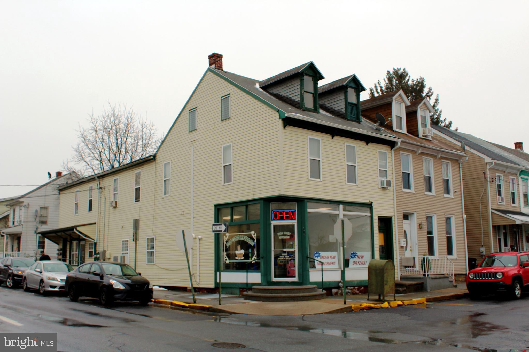 Opportunity awaits with this mixed use property. Operations are currently separated between the first floor public laundry and the second floor apartments. Healthy returns are realized from the first floor laundry business with opportunities for further expansion. Second floor five residential apartments are currently managed and rent from week to week. 2nd Floor units share a common Kitchen/Dining Room and Full Bathroom.