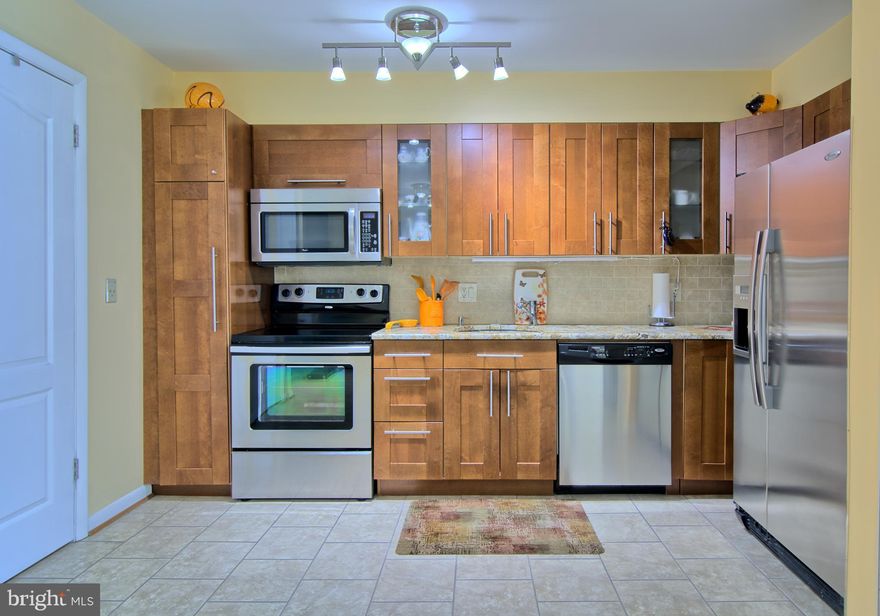 Welcome to this beautifully remodeled second floor 2BR/2BA condo at the Lodge! Almost everything inside has been updated and upgraded. Large Open Updated Kitchen w/ Granite Countertops, Tile Backsplash, Tile Flooring, and Stainless Steel Appliances, and Enclosed Washer and Dryer.  Kitchen also has a wood burning fireplace and plenty of space for a seating as well as access to one of two balconies. Nice and open floor plan Living/Dining Room combo w/  double updated balcony doors leading to the second balcony. Hardwood floors throughout the living/dining and bedrooms. Both Bathrooms have been updated w/ floor to ceiling tile, updated toilets, vanities and lighting.  Other updates include recessed lights and HVAC (5 years).  Plenty of Parking.     Definitely must see!