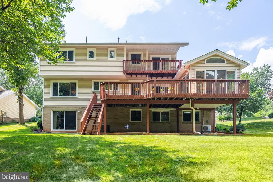 OPEN SUN 2/15, 1-3PM
STUNNING REMODELED CONTEMPORARY 6 BR IN DUFIEF 
Your woodland oasis awaits in this beautifully remodeled, light filled 6 BR, 3.5 bath 2-car garage Mitchell & Best contemporary home in DuFief with over 3,500 square feet of beautifully finished living space on 1/3 acre lot, plus an ALL-SEASON SUNROOM (2022) , backing to natural woods and a creek along DuFief’s private community walking trails. In the spring, the outdoors is a riot of cherry and magnolia blossoms with verdant views the rest of the year. 

SITED on a quiet CUL-DE-SAC street with no through traffic, this fully renovated home features seamless indoor/outdoor living, with vaulted ceiling entryway, 2 levels of hardwood floors, NEW ROOF (2025) and skylights (2025) drenching the home with natural light.  Cooking is a delight in the spacious GOURMET KITCHEN that was fully reconfigured and remodeled (2010) for modern ease and grace with a contemporary layout, granite countertops, new hood (to be installed in February 2026), new appliances, and custom panoramic window overlooking the deck and lush green backyard.  This spacious and light-filled first floor also includes a living room overlooking mature flowering trees in the front, dining room with views of the woods framing the rear deck, a sunken family room with exposed beams, a wood burning fireplace and a fabulous all-season climate controlled sunroom with all new skylights complete this space. 

UPSTAIRS, your private sanctuary is the OWNER'S SUITE with balcony overlooking the backyard, two generous walk-in closets with additional easy access to garage attic storage, and a custom renovated bathroom (2011) with walk-in shower, soaking tub, dual vanities, and Quartz countertops (2021). Three secondary bedrooms with oversized windows framing views of the flowering trees outside are located upstairs, and the hallway bath has been immaculately remodeled (2021) with white custom tilework and modern touches. Hardwood floors and more skylights give the upstairs an airy and open feeling. 

The expansive fully finished WALKOUT BASEMENT leads directly to the flagstone patio and backyard, and features two additional bedrooms, another full bathroom, laundry, and extra storage. This home in the highly coveted DuFief community has direct access to the private Flints Grove walking trail, leading to playgrounds, a basketball court, benches overlooking a pond, and an extended 9 miles of wooded paths on the Muddy Branch Greenway Trail.