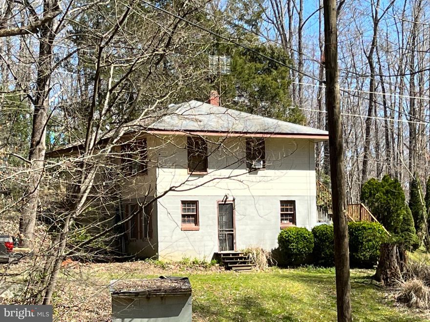 This sweet little gem is nestled on 1.25 acres overlooking a valley of forest. Located near the amenities of Manassas yet tucked away from the bustle in a quiet, tranquil setting. With original hardwoods and lots of beautiful knotty pine, a lower level rec. room with custom bar and abundant storage space it just needs some TLC to make it shine.