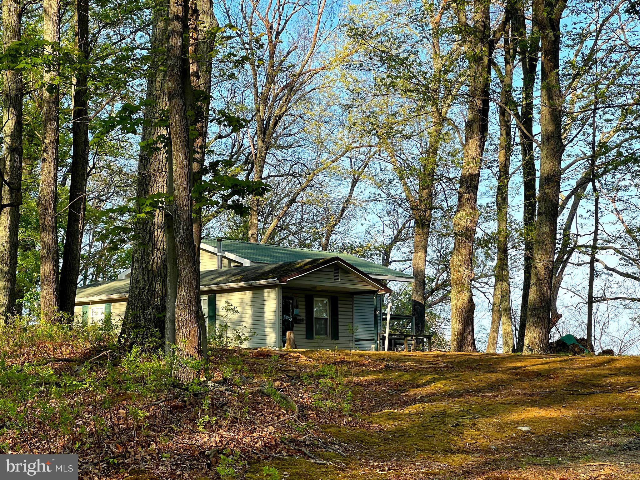 Nice cabin on High Knob with view of mountains to east. Water source is brand new 1200 gallon cistern.
Three interior "parks" that include a nice pond for fishing or to enjoy a picnic. The other two offer panoramic views of valley and the Allegheny mountain range. Easy access and only half hour from Moorefield. Plenty of interior roads to explore and stunning sunsets from atop the rock ledge park. Cabin needs a little TLC but can easily be used as hunting or weekend cabin or a full time residence.