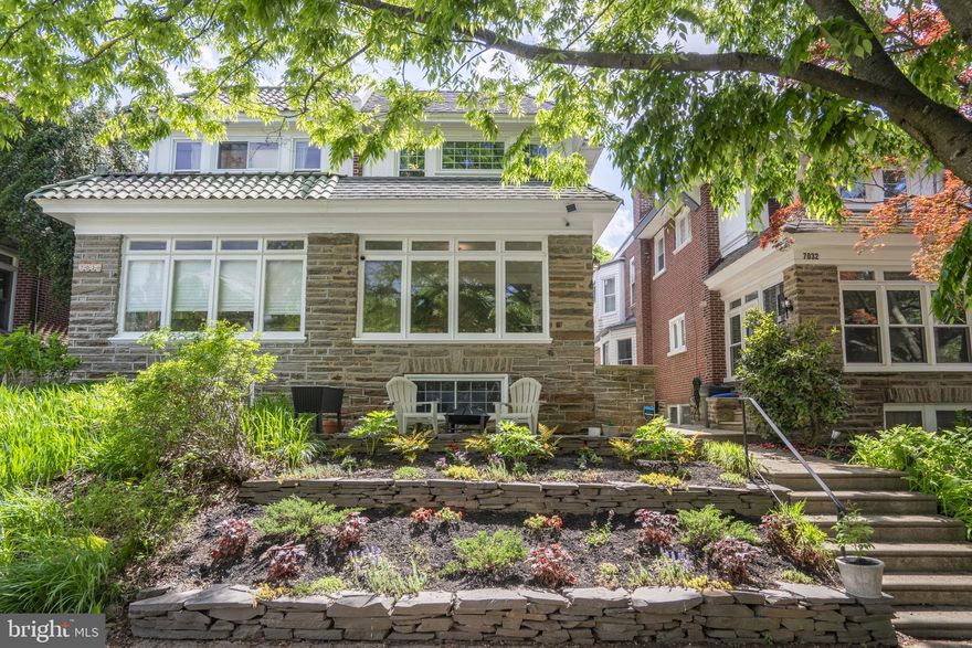 Tucked within the vibrant Mount Airy Village, the heart of West Mt. Airy, sits a two-story stone home where the past and the present shake hands. Originally built in 1925, 7030 Greene Street has been meticulously updated to meet the needs of contemporary living while preserving its classic architectural charm. Fully renovated in 2010 and thoughtfully upgraded in subsequent years, this semi-detached residence combines historical allure with modern comfort and efficiency. The ground floor features an open plan that flows from a sun-kissed solarium, through a cozy living room with a wood-burning fireplace, into a spacious dining room. The renovated kitchen boasts ample cabinetry, expansive counter space, and modern appliances. Climb the stairs to the second level, and there’s space to play with — a plush, sunlit master suite with an ensuite bath, or a generously-sized second bedroom that’s anything but second best. Throughout the home, you'll find beautiful vintage hardwood floors, 1920s woodwork, high ceilings, and custom-built radiator covers. Modern electrical, plumbing, and air conditioning meld seamlessly with the home’s original elegance. The home boasts a beautiful new front garden and a charming outdoor sitting area that not only captivates onlookers but also invites neighbors to pause and say hello. At 7030 Greene Street, you’re just steps from Weavers Way Food Co-op, High Point Cafe, and the Big Blue Marble Book Store. This home isn’t just a place to live but a part of a community that thrives on warm welcomes and spirited involvement. In the past year, this home has seen a number of high-quality upgrades to enhance comfort and reduce energy consumption. A Mitsubishi mini-split keeps the climate just right, a new tankless water heater ensures continuous hot water, and the kitchen sports a new energy-saving LG fridge and dishwasher. The full, unfinished basement presents a blank slate for whatever your heart desires. Speakeasy, workshop, you name it; it’s ready to suit any purpose. New doors on the garage boost both accessibility and security. All in all, 7030 Greene Street is more than just a house; it's a home that respects its past while fully embracing the future. We invite you to become part of its story. Swing by, take a look, and see why this isn't just a place to live — but a place to thrive.