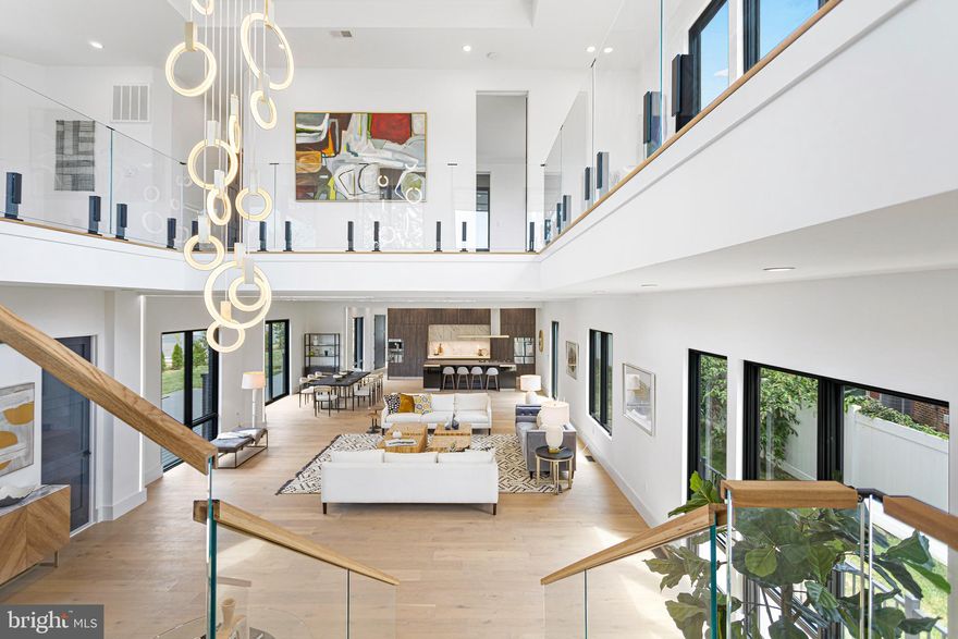 Step into a home that feels alive — bold, elegant, and unapologetically modern mansion in McLean, just moments from Tysons Corner! This contemporary European estate redefines what it means to live beautifully.

From the first approach, every element commands attention — the clean architectural lines, textured stonework, and lush landscaping all working together to create quiet sophistication. A remote-controlled gate opens to a private driveway and a two-car garage with an epoxy floor and EV charger — a sleek introduction to the design language within.

Inside, light becomes art. Walls of aluminum-clad glass, 10+ foot ceilings, and white oak floors create a rhythm of openness and air. The two-story great room anchors the home — dramatic yet warm — with a floating staircase that seems to hover midair. At the center, a chef’s kitchen designed for both precision and performance: Bauformat cabinetry from Germany, Dekton stone surfaces, and an oversized island framed by top-tier European appliances — Liebherr, Smeg, Pitt.

Upstairs, the primary suite is a private sanctuary with a Juliette balcony, sitting lounge, custom dressing room, and a spa-like bath that feels like a boutique retreat — a freestanding tub, a glass wet room, and masterful tilework. Two additional en suite bedrooms, a built-in bar, and a 530-square-foot rooftop deck complete the upper level — an entertainer’s dream in the sky.

The lower level transforms into whatever life demands — a guest suite, a gym, a cinema, or a creative studio — all anchored by a stunning custom wet bar.

Every finish, every proportion, every moment of this home was designed with intention — to be experienced, not just admired. This is McLean modernism at its finest — architectural integrity meets everyday livability, crafted for those who appreciate form as much as function.