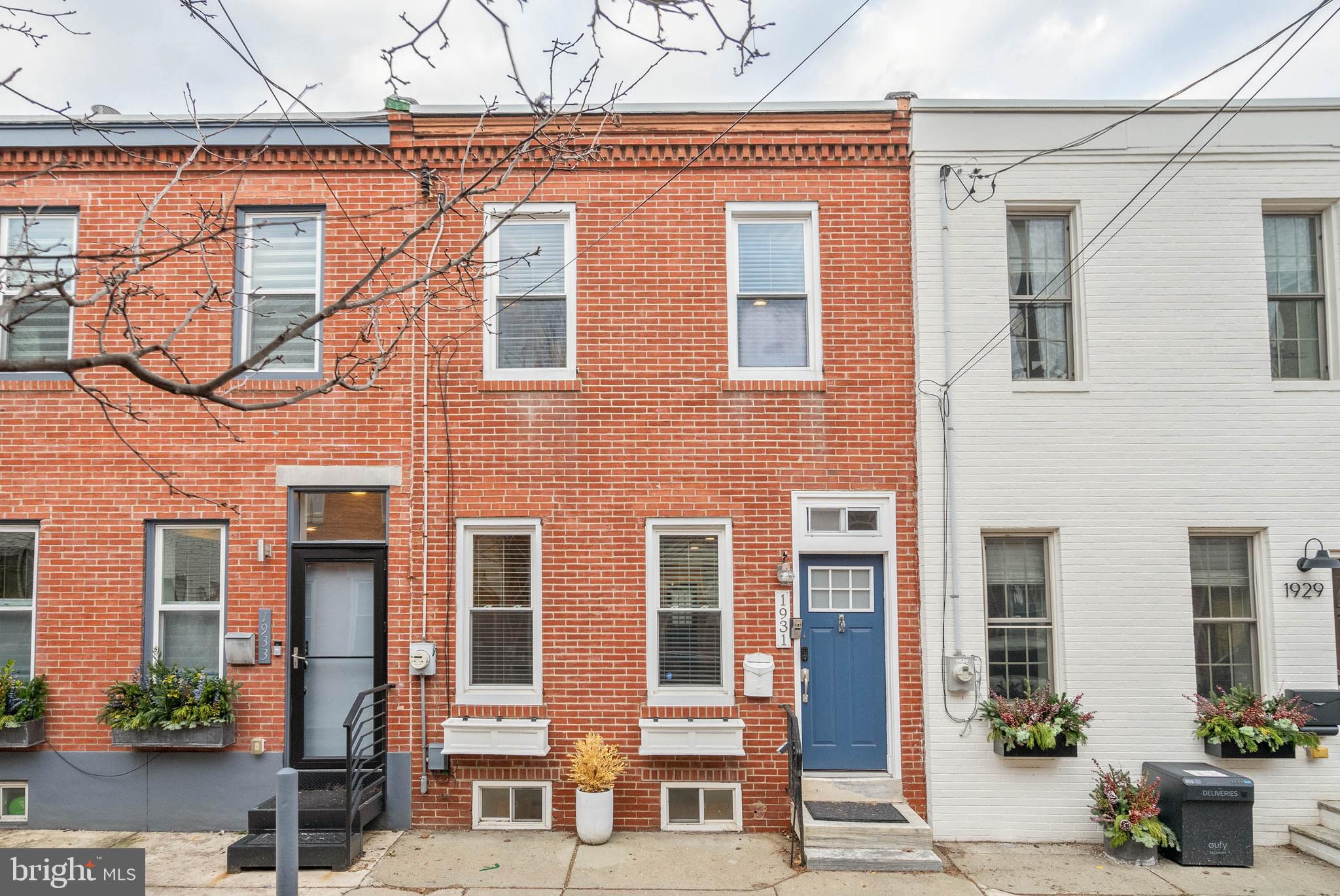 Experience the best of both worlds at 1931 Pemberton St, where the friendly, residential feel of its Graduate Hospital neighborhood is only steps from the city's top dining and shopping in Rittenhouse Square. This renovated home offers 2 beds, 2.5 baths, a finished basement, and a private yard, with sought-after amenities and modern finishes throughout. A hidden, tree-lined block leads to the classic red brick facade and vibrant blue door. Inside, you're welcomed by an open and airy main level with gleaming hardwood floors and high ceilings. A pair of tall windows fill the living room with natural light, while the separate dining area has plenty of space for entertaining. At the rear is an all-white kitchen fitted with shaker cabinetry, stainless steel appliances, stone countertops, a subway tile backsplash, and a built-in wine rack. On warm summer days when you want to get away from the city's hustle, you can escape to your private backyard to relax with a good book or dine al fresco. Down in the finished basement, there's more living space, perfect for a gym or den, along with a half bathroom and the laundry. Up on the second level, the bright primary suite boasts hardwood floors, double closets, and a sleek full bathroom with a glass-enclosed shower. Down the hall is another bathroom and bedroom. In addition to everything inside, 1931 Pemberton St's prime location earns a near-perfect Walk Score of 97! Nearby South St is lined with popular restaurants, shops, and markets. Sprawling Marian Anderson Park is around the corner, plus the extensive Schuylkill River Trail is a few blocks north. There's also easy access to public transit, University City, and I-76. Schedule your tour today!