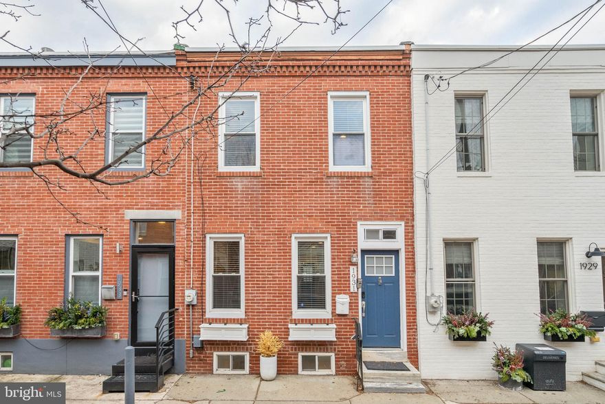 Experience the best of both worlds at 1931 Pemberton St, where the friendly, residential feel of its Graduate Hospital neighborhood is only steps from the city's top dining and shopping in Rittenhouse Square. This renovated home offers 2 beds, 2.5 baths, a finished basement, and a private yard, with sought-after amenities and modern finishes throughout. A hidden, tree-lined block leads to the classic red brick facade and vibrant blue door. Inside, you're welcomed by an open and airy main level with gleaming hardwood floors and high ceilings. A pair of tall windows fill the living room with natural light, while the separate dining area has plenty of space for entertaining. At the rear is an all-white kitchen fitted with shaker cabinetry, stainless steel appliances, stone countertops, a subway tile backsplash, and a built-in wine rack. On warm summer days when you want to get away from the city's hustle, you can escape to your private backyard to relax with a good book or dine al fresco. Down in the finished basement, there's more living space, perfect for a gym or den, along with a half bathroom and the laundry. Up on the second level, the bright primary suite boasts hardwood floors, double closets, and a sleek full bathroom with a glass-enclosed shower. Down the hall is another bathroom and bedroom. In addition to everything inside, 1931 Pemberton St's prime location earns a near-perfect Walk Score of 97! Nearby South St is lined with popular restaurants, shops, and markets. Sprawling Marian Anderson Park is around the corner, plus the extensive Schuylkill River Trail is a few blocks north. There's also easy access to public transit, University City, and I-76. Schedule your tour today!