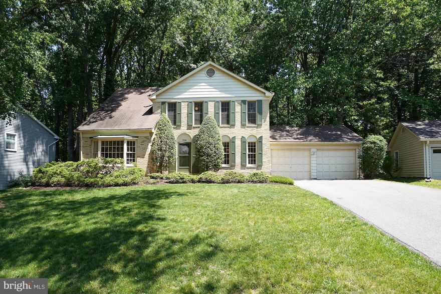 Welcome to 7705 Ivymount Terrace, a traditional colonial ideally situated on a cul-de-sac backing to parkland. Step inside to find wood floors that continue through the main level and upstairs. The main level features a formal dining room, living room, and family room that opens to the eat-in kitchen. Enjoy outdoor living with both a back deck and screened-in porch. A laundry/mudroom with garage access adds everyday convenience.  Upstairs, the primary suite offers a dressing area and walk-in closet, along with three additional bedrooms and a hall bath. The walk-out lower level is fully finished, providing flexible space for recreation, work, or guests.  While the home would benefit from updates, it offers strong bones, a fantastic setting, and an unbeatable location close to shopping, restaurants, and major commuter routes.