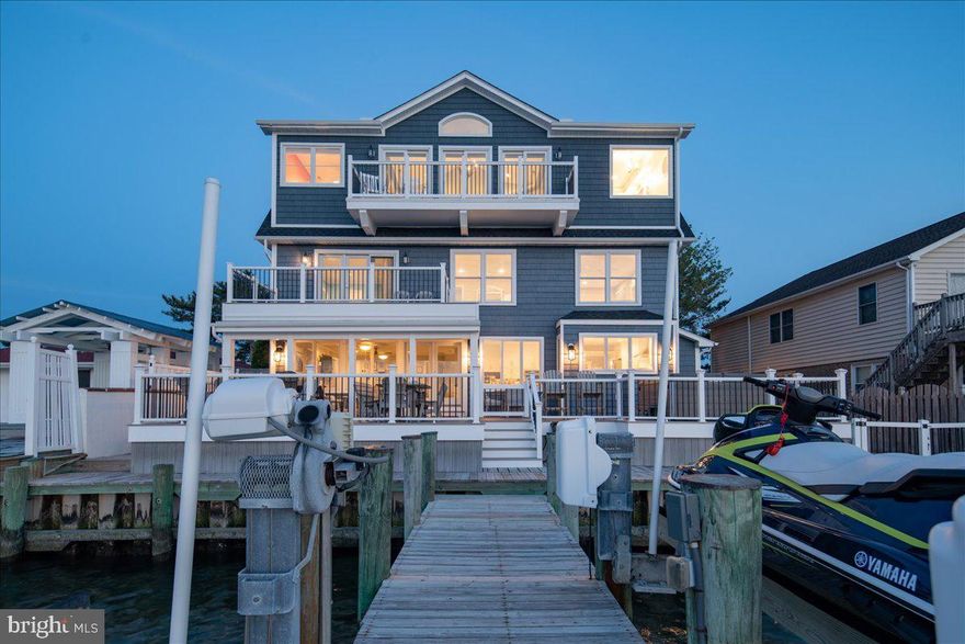 Location! Location! Location! Stunning LUXURY  DIRECT BAYFRONT custom home hits the market!  Spectacular 7BR/5.5BA with unobstructed views of the bay. Direct bay front homes are rarely available for sale in Ocean City and this beautiful home overlooks the bay and comes with 2 boat lifts right out your back door. This home was renovated last year by Bradley Construction, Inc.  From the minute you pull up you will fall in love with the custom paver driveway and covered wrap around front porch.  As you enter the home you will be mesmerized by the expansive open bay views.  Watch sunsets from inside the comfort of your own home or from the large rear oversize deck while relaxing and enjoying crab feasts or barbecuing with family and friends. The family room has plenty of space for large gatherings and there's a gas fireplace for year-round enjoyment. The gourmet kitchen has plenty of cabinet space, quartz countertops, a center island, and stainless-steel appliances. There are two separate dining areas on the first floor. On the second floor you will find 3 bedrooms and 2 baths.  One could be a second master suite with custom deck and large master en suite. On the third floor you will find a lavish master suite with breathtaking bay views with fireplace!  Enjoy your morning coffee on the expansive balcony and you will love the soaking tub that overlooks the bay. There is also a large custom spa shower.  There are 2 additional bedrooms on this floor as well as an additional full bath and laundry room.  Off the garage you will find a finished bonus room with full bath that can be a 7th bedroom or recreation room.  This custom home is one of a kind and close to the beach,  restaurants and everything Ocean City has to offer.  The large expansive outdoor entertaining space is amazing.  This past year has been tough. It's time to stop putting off your dreams and start making Ocean City memories that will last a lifetime.  Come take a look at this incredible home today, before it's SOLD.