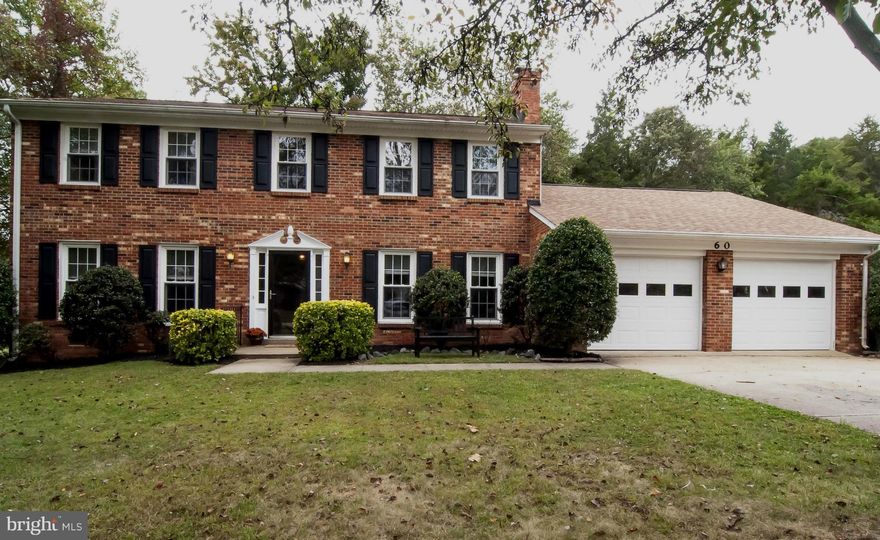 Classic all brick colonial with 2 car garage.  Very nicely updated w/ new windows, roof, heat pump, garage doors. Beautifully updated baths w/ceramic tile & new vanities.  Newly installed laminate on the main level. Home features generous-sized rooms for lots of living space.  Traditional floor plan with formal living & dining.Large family rm off kitchen w/ fireplace,main level study.Wooded yard