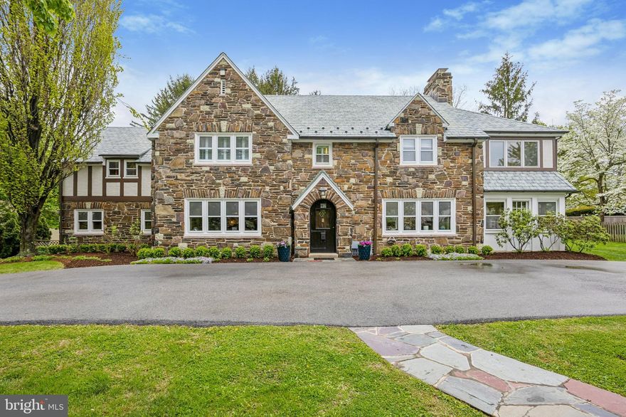 Nestled on one of the most picturesque streets in Lower Merion, this stunning stone tudor effortlessly blends timeless architectural charm with modern-day functionality. Perched gracefully atop a gentle hill, the home welcomes you with a slate walkway and a circular driveway, setting the tone for the exceptional experience inside

Step into the inviting center hall, flanked by dual coat closets for convenience. To the right, the spacious living room exudes warmth and elegance, featuring a stone gas fireplace, hardwood floors,recessed lighting and deep-set window sills that let the sunlight pour in. Adjacent to the living room, you'll discover the sunroom—a true retreat with its own stone gas fireplace, a wet bar with custom built-ins, and direct access to the backyard.
 The elegant dining room, featuring hardwood floors and deep-set window sills, flows effortlessly into the kitchen and  also through French doors into a large, comfortable family room. Here, you'll find more hardwood floors, recessed lighting, and classic plantation shutters, creating a warm and inviting space for gatherings. A nearby powder room and access to a serene screened-in porch with slate floors offer the perfect retreat for relaxation.

The kitchen houses the washer and dryer and has a very large storage closet, pantry, and double ovens and plenty of storage cabinets. It opens into a sunlit breakfast room addition  with a cathedral ceiling and skylight highlighted by a beautiful bay window that fills the space with natural light. From here, step outside to a private patio, lush yard, storage shed, and even a swing set—perfect for outdoor fun and entertaining. This home offers comfort, charm, and functionality in every corner.
Enter the second floor where the primary suite is nothing short of a personal sanctuary. Anchored by a stunning decorative marble fireplace, this space is adorned with recessed lighting, custom built-ins, and two spacious closets. The updated en-suite bathroom feels like a spa retreat, boasting a large shower with a built-in seat, double sink, two medicine cabinets, heated floors and timeless plantation shutters. But the luxury doesn’t stop there—step into the expansive dressing room, complete with additional closet space, built-ins with drawers, a makeup sitting area, and even a private sink and toilet.

Adjacent to the suite, French doors lead to a versatile bonus space with soaring cathedral ceilings, a skylight, and custom built-ins—a perfect spot for a home office, workout area, or creative retreat. The primary suite is thoughtfully tucked away from the other bedrooms, offering a peaceful escape.

The second floor features three additional bedrooms, each with ample closet space and plantation shutters. One of the bedrooms includes its own en-suite bath and dual closets, while the others share a w hall bathroom. Storage is no issue here, with multiple closets and even attic access via Bessler stairs.
The recently finished basement is a versatile haven designed to meet all your needs. It boasts a spacious playroom /rec room featuring  luxury vinyl tile flooring and recessed lighting for a modern touch. There is a large storage closet in this room as well as a convenient sink with extra cabinet space- perfect for creative projects or practical everyday projects. In addition there is a cedar closet and additional stoage space. A full bathroom with a shower adds functionality, and the mechanicals are neatly tucked away. This is a space where comfort and practicality come together seamlessly—ready to adapt to your lifestyle.

This home masterfully blends thoughtful design and modern convenience, creating a haven that’s ready for you to make your own.This is more than just a home- it is a lifestyle offering comfort and a prime Merion Station location. Walk to award winning Lower Merion schools, restaurants, parks,library, shops, and east access to center city and major highways.