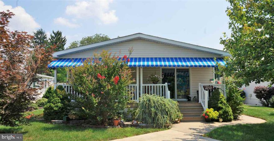 Beautiful home in an active adult community. Large custom kitchen with center island and lots of cabinets. Built in entertainment center in living room with cathedral ceiling. Walk in closet in Master suite. $15,000 walk in tub and new flooring in bathroom. New awining, water heater, wheel chair ramp, living room carpeting and thermostat. Two sheds for storage. Lovely trees and plenty of parking.