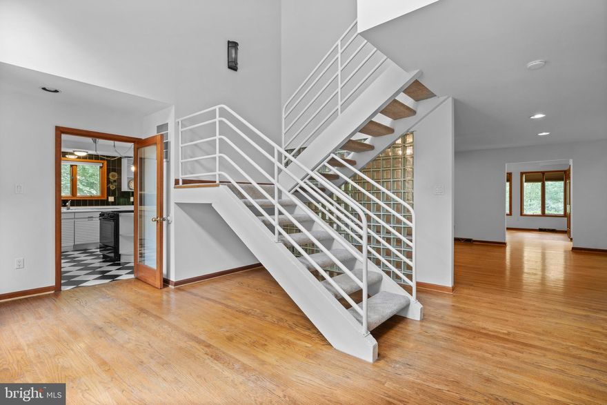 Discover a truly one-of-a-kind retreat at 8095 Plowden Drive:  Take a step back from the everyday hustle and walk into a serene contemporary retreat nestled on 2.5 acres of lush, wooded land.  A contemporary cedar-sided gem blends modern design with rustic charm. Imagine walls of windows that flood the interior with natural sunlight, panoramic views of the surrounding landscape, a warm brick fireplace anchoring the 3,500+ sq. ft., and a spacious deck that invites entertaining or peaceful solitude. 

The cedar exterior blends beautifully with nature, while the spacious partial wraparound deck, recently painted (2025) is perfect for entertaining or simply relaxing in the quiet. Enjoy private walking trails, a gentle stream, and abundant wildlife right in your backyard.

This home features a brand-new roof (2025), a new front storm door (2025), and all new window cranks (2025), crawlspace  cleanup/remediation completed including new vapor barrier, and insulation (12/2025) adding COMFORT and PEACE of mind. Recently painted (2025), new carpet (2025), and professional cleaning make it move-in ready.

A versatile additional suite with its own entrance with rough in for a bathroom offers endless possibilities; maid’s quarters, a workshop, home office, guest space, or extra storage.

With a two-car attached garage and a paved driveway offering plenty of parking, this property combines privacy, character, and convenience. If you’ve been searching for a serene escape with modern updates and unique style, this is the one you won't want to miss.