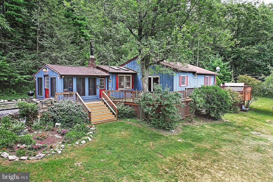 Welcome to your mountain paradise at 535 Maryland Ave, perched on a serene five-acre expanse atop Bear Mountain in the captivating landscape of Adams County, Pennsylvania. This exceptional property offers a truly enchanting retreat that seamlessly blends modern comforts with rustic charm. 
Upon entering, you'll be greeted by a sense of tranquility and seclusion. The property is enveloped by forests on all sides, providing an unmatched level of privacy while remaining easily accessible. Nature enthusiasts will revel in the abundant woods that extend for hundreds of yards, ensuring a peaceful haven away from the bustle of everyday life.
The heart of this mountain retreat is a lovingly restored cabin that embodies both warmth and contemporary living. The cabin exudes a rustic ambiance, boasting a wood-burning fireplace in the cozy living room—a perfect spot to unwind on chilly evenings. The cabin itself has been thoughtfully renovated, boasting modern amenities while retaining the aura of a traditional wooden cabin. From the kitchen with its updated appliances and cabinets to the sunroom that bathes the interiors in natural light, every aspect of the living space has been meticulously reimagined to meet contemporary standards while preserving its cozy character. Ceiling fans grace every living area, ensuring comfort year-round, while the satellite television and high-speed DSL internet connectivity offer the convenience of modern entertainment and communication. The primary bedroom and bathroom have been expanded and modernized, while the second bathroom has been tastefully updated. Whether you are looking for a second home or an active retirement home this property fulfills the practical needs with 4 bedrooms and 2 full bathrooms.
Adjoining this is an expansive deck that offers peaceful views of the morning sunrise with coffee, but also two separate dining areas for enjoying meals amidst nature's beauty.
Nature lovers will find much to explore here. A spring-fed swimming pond beckons during the summer months ensuring endless fun on the water. For those seeking relaxation, a hot tub provides a private sanctuary for unwinding while soaking in the stunning surroundings. And the sloping downward yard is the perfect runway for winter time sledding.
The property's landscaping is adorned with a beautifully maintained garden, a volleyball net for friendly matches, a hammock for lazy afternoons, and a mature fruit-bearing apple tree that adds a touch of orchard charm. An outdoor fire pit invites gatherings under the stars, while the converted barn offers ample storage space for equipment and belongings.
The property has also been enhanced with practical improvements such as a water diversion and drainage system, enclosed crawl space, and a leveled driveway with ample parking space.
Conveniently located just a short fifteen-minute drive away, 535 Maryland Ave offers easy access to the renowned Gettysburg National Park, the National Apple Museum, Piney Apple Golf Course History, the famous Appalachian Trail, fishing and shopping. Whether you're in need of daily essentials or looking for a leisurely shopping experience, you'll find a range of retail outlets, boutiques, and specialty stores within a short drive.
Book your showing today!