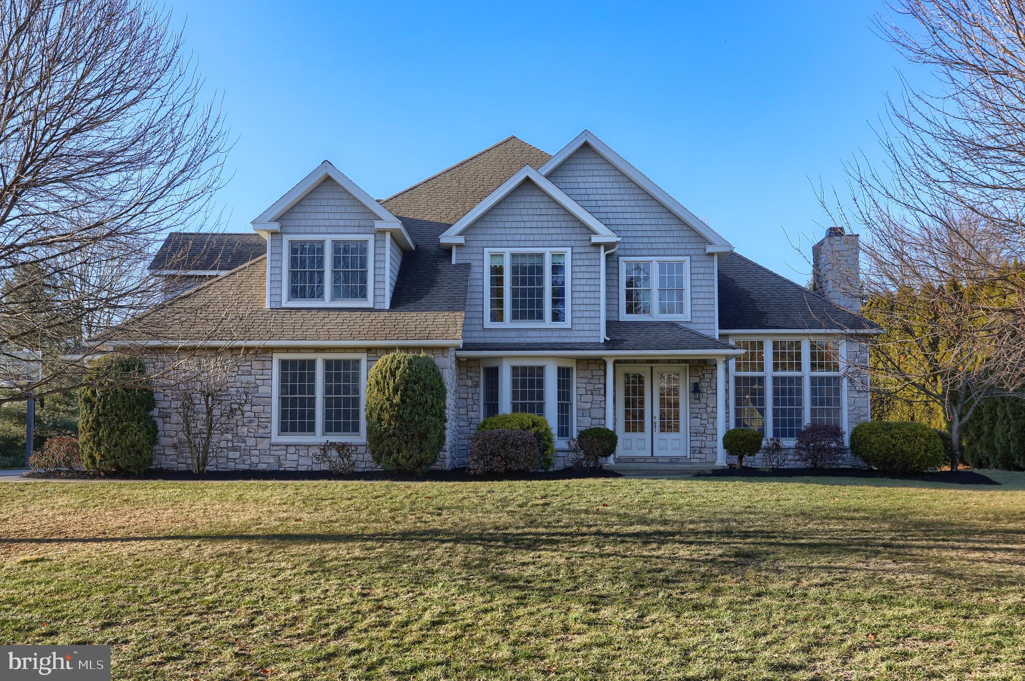Distinguished home located in Country Club View, featuring a sprawling 3/4-acre private homesite and almost 3,500 square feet of living space. As you step inside, you are greeted by a striking two-story foyer with a dramatic curved staircase and expansive windows that flood the space with natural light. The rich warmth of hardwood floors flows seamlessly throughout the main level, adding both elegance and durability. The formal living room and dining room feature 13-foot tray ceilings, beautiful large windows and a cozy natural gas fireplace with marble surround and mantel. The combination of high ceilings and open layout contributes to the home’s airy and expansive atmosphere, making it perfect for both everyday living and creating an immediate sense of grandeur and spaciousness. The kitchen is a chef’s dream, featuring a large, central island that serves as both a workspace and a gathering spot. This area is designed for both style and function, with granite countertops and pull-out shelving in the cabinets providing easy access to kitchen essentials and maximizing storage space. The family room steps down to create a more relaxed, inviting atmosphere, perfect for family gatherings or quiet evenings. Another beautiful fireplace and built-ins serve as the room's focal point. Windows line the walls, allowing natural light to flood the room, enhancing the openness and connection to the outdoors. The main level also includes 9-foot ceilings, a spacious office, a bonus room that can serve as a fifth bedroom, full bath, and large laundry room. The second level offers a luxurious primary suite with space for relaxation and comfort. A cozy sitting area within the room creates an intimate nook for reading or unwinding at the end of the day. The ensuite bathroom features a soaker tub and a walk-in shower plus large walk-in closet. There is another spacious bedroom with its own private full bath and skylight. On this level there is two additional large bedrooms with a shared jack and jill bathroom. The lower level is an expansive space offering an exterior entrance and endless possibilities to finish as a home theatre, recreation area, additional bedrooms, and additional home office. A Reverse Osmosis water filtration system provides purified water through the entire home. The expanded three-car attached garage offers ample space to comfortably park vehicles, along with extra space for storage or a workshop area. The large yard surrounded by mature trees and landscaping offers an expansive outdoor space, providing plenty of room for outdoor activities. A spacious deck features plenty of room for comfortable seating, creating an inviting and versatile outdoor retreat. Showings will begin January 15th 2025, call for your private tour!