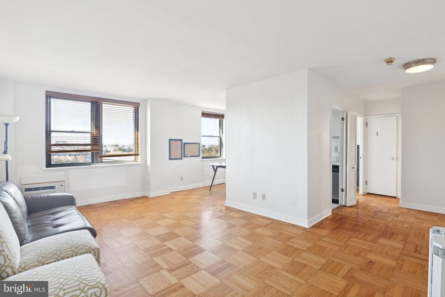 Light filled two bedroom with beautiful views of The Philadelphia Art Museum and Schuylkill River at 2601 Parkway Condominiums. This home offers two bedrooms, one bathroom, a well-designed layout, parquet wood floors and oversized windows throughout. The spacious great room boasts a large living area and separate open dining space, perfect for entertaining. The well-equipped galley style kitchen provides ample cabinet and counterspace, stainless steel appliances, and a tile floor. The large primary bedroom enjoys a corner of oversized windows and a deep wall closet. The second bedroom is generously sized and has excellent closet space. Both bedrooms enjoy use of a full hall bathroom with tub shower and white tilework throughout. Residents of 2601 Parkway Condominiums enjoy a 24 hour front desk concierge, a shuttle bus to Center City, a community room with kitchen, meeting room, children's playroom and a 24-hour fitness center. 2601 Parkways Condominiums is pet friendly.