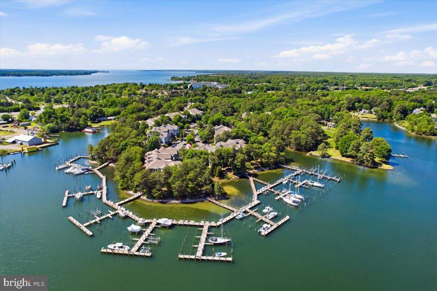 Waterfront condominium with deep-water boat slip for sale in the highly desirable Solomons Landing community on Back Creek in Solomons. This beautifully updated 2BR/2BA corner-unit condo with den/office offers luxury waterfront living in the heart of Southern Maryland near the Chesapeake Bay and Patuxent River. Located on a desirable mid-level floor, this quiet retreat is ideal as a primary residence, weekend getaway, boating property, or second home near Washington DC. Interior upgrades include luxury vinyl plank flooring, all-new stainless appliances, granite kitchen and wet bar countertops, marble-tiled bathrooms, custom vanities, designer fixtures, and Mecho motorized shades. The spacious screened porch overlooks a peaceful waterfront setting with exceptional privacy and natural views. Deep-water boat slip conveys, offering convenient boating access to Solomons Harbor, the Patuxent River, and Chesapeake Bay destinations. Residents of Solomons Landing enjoy resort-style waterfront amenities including pickleball and tennis courts, outdoor pool, fitness center, walking and biking trails, kayak and paddleboard launch, piers, marina access, and an active community center. Conveniently located near Solomons Island waterfront restaurants, marinas, shopping, and Annmarie Sculpture Garden & Arts Center. Rare opportunity to own an updated waterfront condo with deep water boat slip in one of Maryland’s premier boating communities. ***All furnishings available. No partial furnishing packages.***
