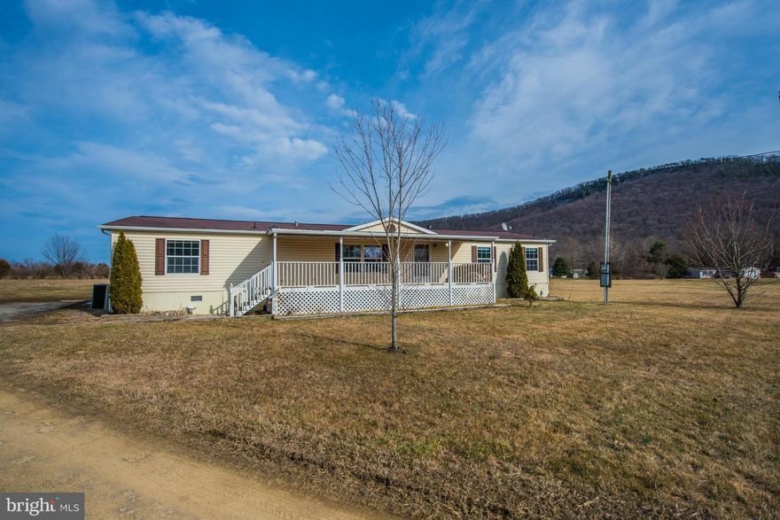 This very nice spacious double wide is on permanent foundation comes with 2 lots for total of 4.24 acres. Has 3 BDRM 2 BA with wood burning fireplace in the family room, Master BR with Master BA and walk in closet. 2000 sq.ft. of open living space with covered decks/porches front and back of home. Also has workshop and storage shed. Enjoy the beautiful mountain views and nearby North River.