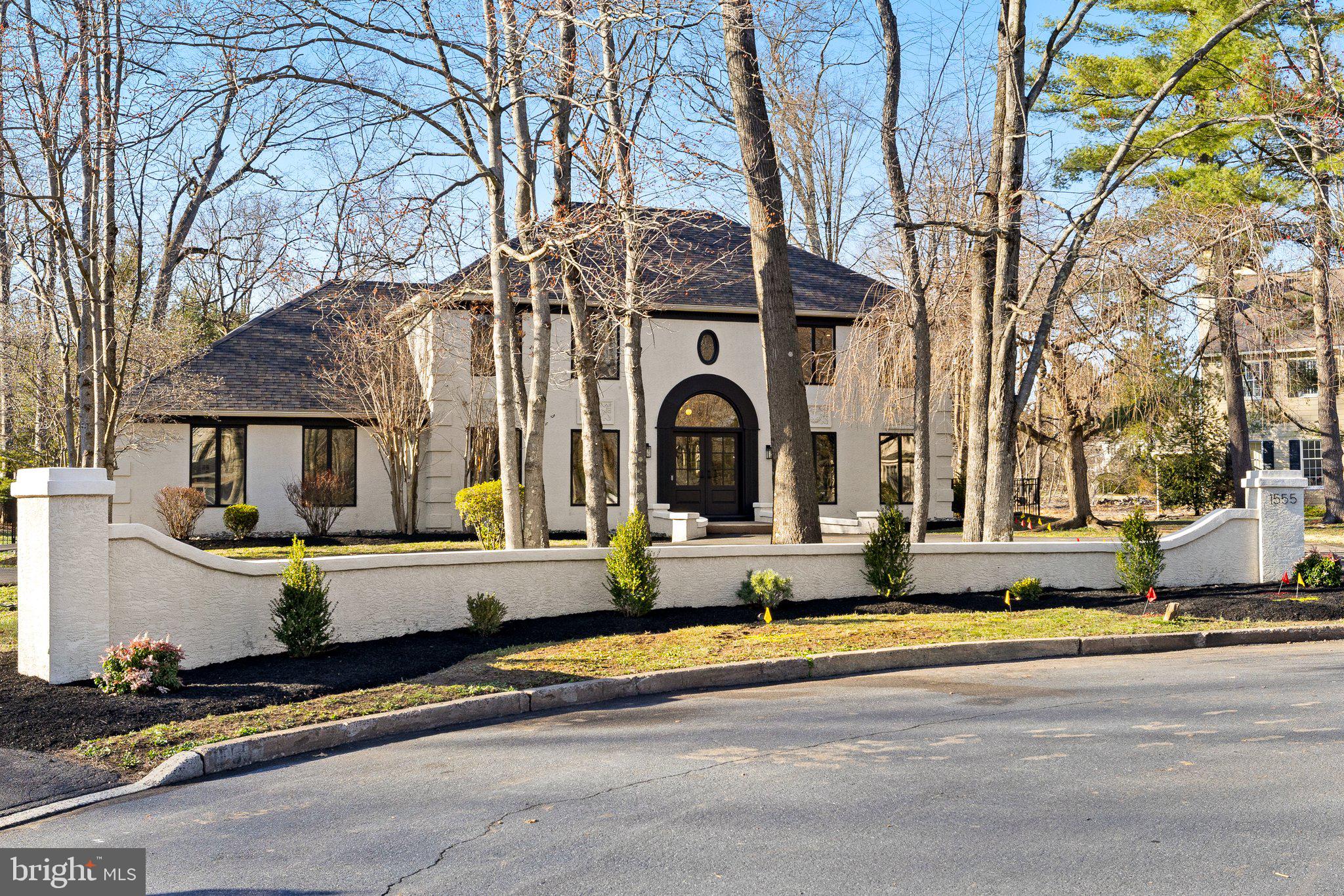 Look no further! This is the home you have been looking for! Completely renovated from top to bottom, this exquisite custom home is located on a cul de sac in a very tranquil neighborhood of Maple Glen. 4 bedrooms, 3.5 bathrooms, this 5657 square-foot masterpiece has been carefully redesigned from top to bottom where elegance meets contemporary sophistication. Upon entering, you are greeted by a foyer adorned with a diamond checkerboard patterned custom limestone and Italian arabescato marble floor, leading to a curved white oak staircase with custom black metal railing—a true testament to the home's grandeur. From the foyer, the custom-built arched door opens into an office boasting gorgeous new built-ins with paneling on the walls and glass pocket doors opening up into a bonus room that is bright with natural light and windows all-around overlooking the outdoor swimming pool. The two story great room boasts an elevated raked walnut ceiling, complemented by custom-painted lime wash accent walls and a steel leathered granite fireplace, exuding warmth and style while providing full view of the gourmet kitchen. The completely renovated chef’s dream eat-in kitchen is equipped with top of line new stain steel appliances, a Viking 6 burner gas stove, double oven, in-drawer microwave, leathered granite countertops, beverage refrigerator as well a large island with quartz countertop, plenty of cabinetry and space for a table for family gatherings. Right off the kitchen, access to the two-car attached garage is available as well as a luxurious mudroom/laundry area designed with custom bluestone tile floors, white oak cabinetry, a dog wash station with custom handmade tiles, and a new GE Profile washer and dryer built into cabinetry and a full-light glass door with access to the backyard. Rounding out the main floor, the stylish dining room highlights a gorgeous custom ceiling and light fixtures that provide just the right ambience for family gatherings with the convenience of a butlers pantry newly built offering dual purpose as a desk and a completely updated powder room with terrazo flooring. Upstairs, the primary suite is a private retreat with two walk-in custom closets, a luxurious bathroom that provides a massive walk-in tiled shower, “oversized freestanding soaking tub”, a double vanity plus a water room. Three other spacious bedrooms and fully renovated hall bathroom with a stylish black penny-tiled shower complete the second floor. The finished basement offers endless possibilities for creating additional entertaining and/or recreation space and features an additional bonus room having access through French doors providing a closet and full bathroom for extra convenience, easily used as guest suite or 5th bedroom, plus plenty of room for storage. Noteworthy features include premium European White Oak hardwood floors throughout, new solid doors with satin brass Emtek hardware, upgraded electrical systems, custom recess dimmable lighting through out, freshly painted, new doors throughout including new front door and new exterior doors. Outside the private outdoor oasis offers a large patio that overlooks the in-ground swimming pool and private backyard that allows for plenty of relaxation and entertainment for family and friends. This truly special designed home is located in the award-winning Upper Dubin school district and is close to public transportation while providing easy access to major highways and plenty of dining and shopping options.