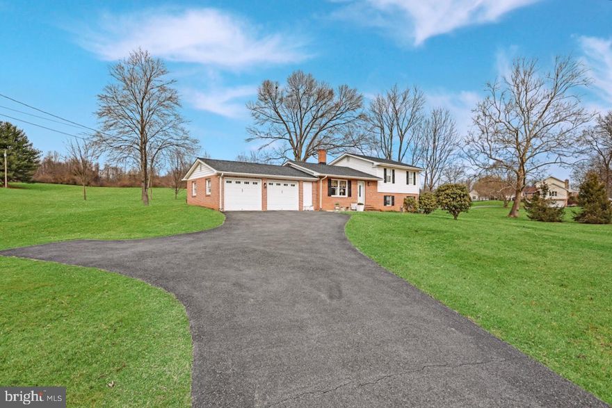 3 Bedroom 2.5 Bath Split Level resting on an acre of land with beautiful mature landscape! NEW 50 Year architectural roof, stainless appliance package in kitchen, windows in bedrooms, 85 gal hot water heater, UV Light water softener, and insulated siding! Main level includes hardwood flooring throughout the Living Room with Brick chimney that could easily have a gas insert or fireplace installed. Kitchen with stainless appliances and adjoining Dining Room. Upper level Bedrooms all have hardwoods including the Primary Owner's Suite with attached private Bath. The two additional bedrooms share a full bath. Lower level has a spacious Recreation Room which walks out to the yard, laundry room and storage. Additional storage can be found in the attic area above the garage and Primary Bedroom. 2 car front load garage and expanded paved driveway offer plenty of parking space! Minutes to downtown Charles Town for shopping and dining!
