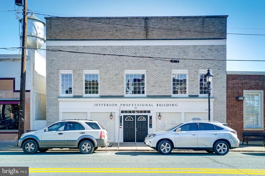 Fantastic opportunity in the heart of downtown Louisa! Welcome to The Jefferson Professional Building, a well-maintained commercial property offering 7,224 square feet of versatile office space. This two-story building features six separate office suites, ideal for multiple businesses for an income producing investment. 
The main level includes four spacious suites, each with five rooms, while the second level offers two additional suites with four offices each. Each suite has its own bathroom. The property currently has two suites leased, providing immediate rental income. This building also has its own dedicated parking lot with 12 spaces (two per suite) and is conveniently located behind the building. Each suite also has their own heat pump.  New paint in every suite except for the two that are actively leased. Perfectly positioned on Main Street across from the Louisa Courthouse, this location is within walking distance to dining, shopping, and banking, and just 15 minutes to I-64, an excellent spot for professional services, medical offices, or investment use.
Whether you’re looking to grow your business or build your investment portfolio, this property offers outstanding visibility, accessibility, and potential.