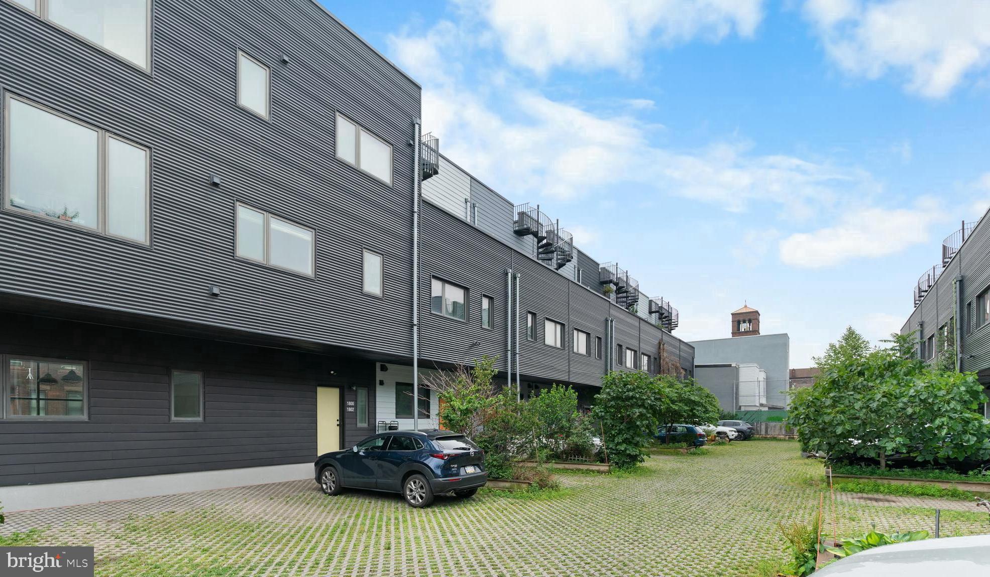 Open House Sunday 12-2 PM! The owner is offering a $10,000 credit toward the buyer's interest rate buydown! Only a $200/YEAR condo fee. Deeded parking. This place is perfect for you if you want to be in South Philly for all of its quiet, residential lifestyle and walkability to amazing dining options, but don't want to deal with all the home ownership headaches. Here’s a rare availability at reNEWBOLD - a modern community development with eco features and amazing finishes. Constructed in 2016 and built to LEED-Platinum standards, the 18-home and 2-unit community at 16th & Moore pairs insulated walls, reduced utility bills, green roofs & surfaces with a condo fee of only $200/year, which is extremely low compared to other developments. Every unit gets its own deeded parking spot!
Loved by neighbors, Little Susie’s Coffee & Pie is just a 1-minute walk away, and you can get coffee & freshly baked pies. South Philadelphia Tap Room and Second District Brewing are just a few blocks away, while the celebrated dining corridor on East Passyunk Avenue sits about a ten-minute walk away. The Broad Street Line (Tasker-Morris) is a six-minute walk, putting Center City seven quick stops away. Grocery options, pocket parks, and bike routes fill in the daily-life picture, so the car can often stay parked. This is a beautiful location for people to reside in.
When you walk into the unit, you will be treated to the beautiful open-floor concept kitchen with a massive peninsula, dining & living areas. Because it is a corner unit, you have tons of natural light coming in through those big windows facing North & East. The kitchen has Bosch appliances, quartz counters, and a breakfast bar. Living & dining areas have plenty of space for entertaining your guests & family.
When you walk down the hallway, you will see the first bathroom, the washer & dryer, and two bedrooms, which sit on opposite ends for privacy. Both of them face West, and the first bedroom has a private bathroom. Throughout the unit, you have beautiful hardwood floors. City taxes remain minimal through the 2026 tax-abatement year.
Sustainable construction, ultra-low carrying costs, easy maintenance, parking, rapid appreciation of the development & neighborhood, and a walk-everywhere South Philly address—1800-2 S 16th St #B makes everyday living refreshingly simple.
