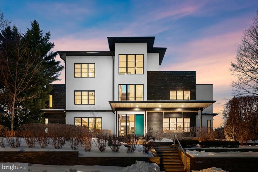 *Just Listed & Open Sunday* A modern architectural statement designed by ODE Design (formerly Sagatov Design+Build)  in 2015, this exceptional residence combines striking design, luxury finishes, and thoughtful functionality, set on one of Arlington’s rare elevated sites with panoramic views of the DC landscape. The four-level custom home offers approximately 6,700 square feet of meticulously designed living space, serviced by an elevator to all levels. Highlights include a top-floor kitchenette and an expansive rooftop terrace with panoramic Washington, DC views and an outdoor fire pit—ideal for memorable entertaining.

The main residence features five bedrooms and four-and-a-half baths, with refined architectural details throughout, including soaring ceilings, a dramatic steel and wood staircase, and expansive walls of glass. The chef’s kitchen is outfitted with a full-size panel-front refrigerator and freezer, large wine storage fridge, built-in countertop steamer, and a premium appliance package. The kitchen flows seamlessly into the family room, where large sliders open to a screened porch and outdoor kitchen. Indoor-outdoor living is enhanced by a screened porch, outdoor kitchen with built-in grill and pizza oven, putting green, and professionally designed private grounds with irrigation, landscape lighting and basketball pad. 

The third level is anchored by the primary suite, featuring a gas fireplace, dual walk-in closets, and a spa-inspired bath with a skylit walk-in shower, soaking tub, double vanities, and private water closet. Two additional bedrooms on this level offer custom closet systems, en-suite baths, and large windows with tailored window treatments. A well-appointed laundry room completes the floor, with a folding station, hanging rack, and ample storage.

The lower level includes a spacious recreation room with gas fireplace, a fifth bedroom and full bath, a large storage room with built-in organization, and a utility room equipped with a second refrigerator and dog-washing station. A standout feature is the underground tunnel connecting the main house to the 1,320-square-foot three-car garage, topped by a private one-bedroom, one-bath apartment—perfect for guests or  au pair. Additional highlights include solar panels with Tesla battery backup, whole house generator for peace of mind, heated driveway and walkways, invisible dog fence, landscape design by Brinitzer Landscape Architecture, built-in speakers and comprehensive smart and energy-efficient features throughout. A house like this is rarely available and the A+ location makes this a property a must see.