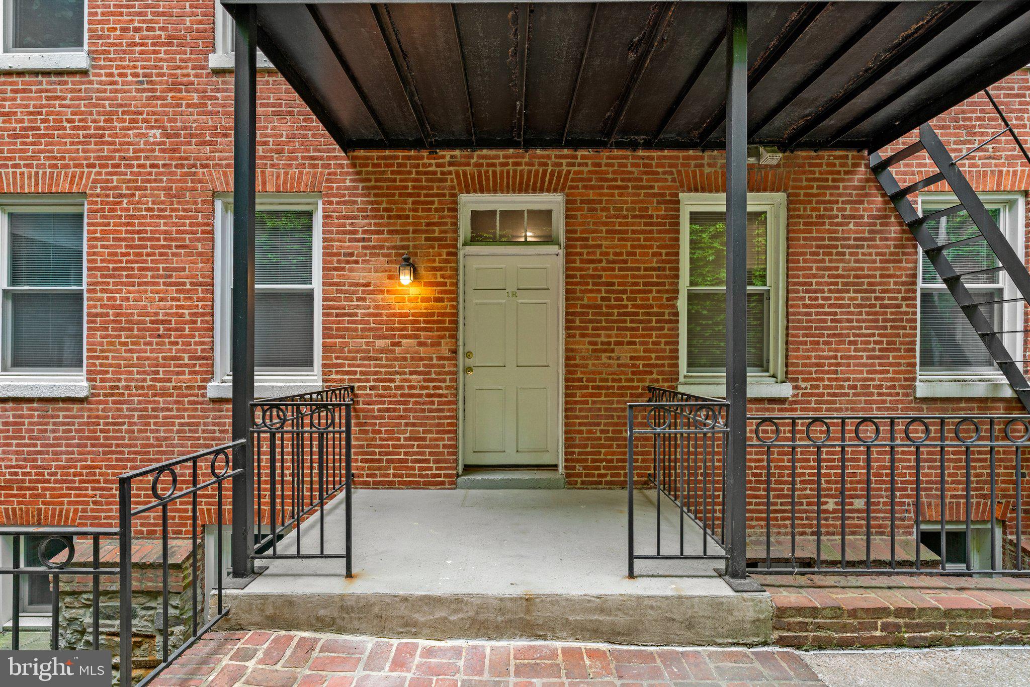 Welcome to 216 W Monument Street, Unit 1R — a charming blend of historic character and modern convenience! Step into the inviting living room, featuring original wide-plank hardwood floors, a graceful curved plaster wall, and a classic stone fireplace. The thoughtfully designed kitchen offers stainless steel appliances, abundant countertop space, and seating for barstools — perfect for casual dining and entertaining. Two versatile rear rooms provide flexible options for bedrooms, a home office, or a cozy den. The updated full bathroom includes a convenient stackable washer/dryer. Recent updates include a brand-new hot water tank (2024) and new flooring in the middle and rear rooms. Access the unit through a beautiful gated courtyard, and enjoy all that vibrant Mount Vernon has to offer — just one block from Mount Vernon Marketplace’s dining scene. Parking is available off-street or with city permit. Discover the perfect mix of history, style, and location in the heart of Baltimore!