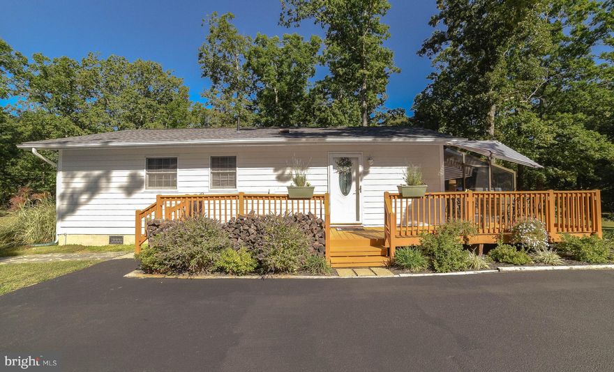 In the heart of Breton Bay, this wonderful rambler affords you the convenience of living close to town yet the luxury of your own private space.  Just minutes from the golf course, pool and the beach, this adorable home is perfect for down-sizing or would be an ideal starter home with over  .6+ acre of land. Three bedrooms and one large newly remodeled bathroom ,  stainless appliances, hardwood flooring in LR, DR and kitchen, a fabulous deck and a greenhouse off the front of the house make certain this home won't last. The outside gives way to a large  paved driveway, a one car detached garage, as well as a backyard firepit. Washer, dryer and hot water heater are all new/newer. Come take a look! No HOA.