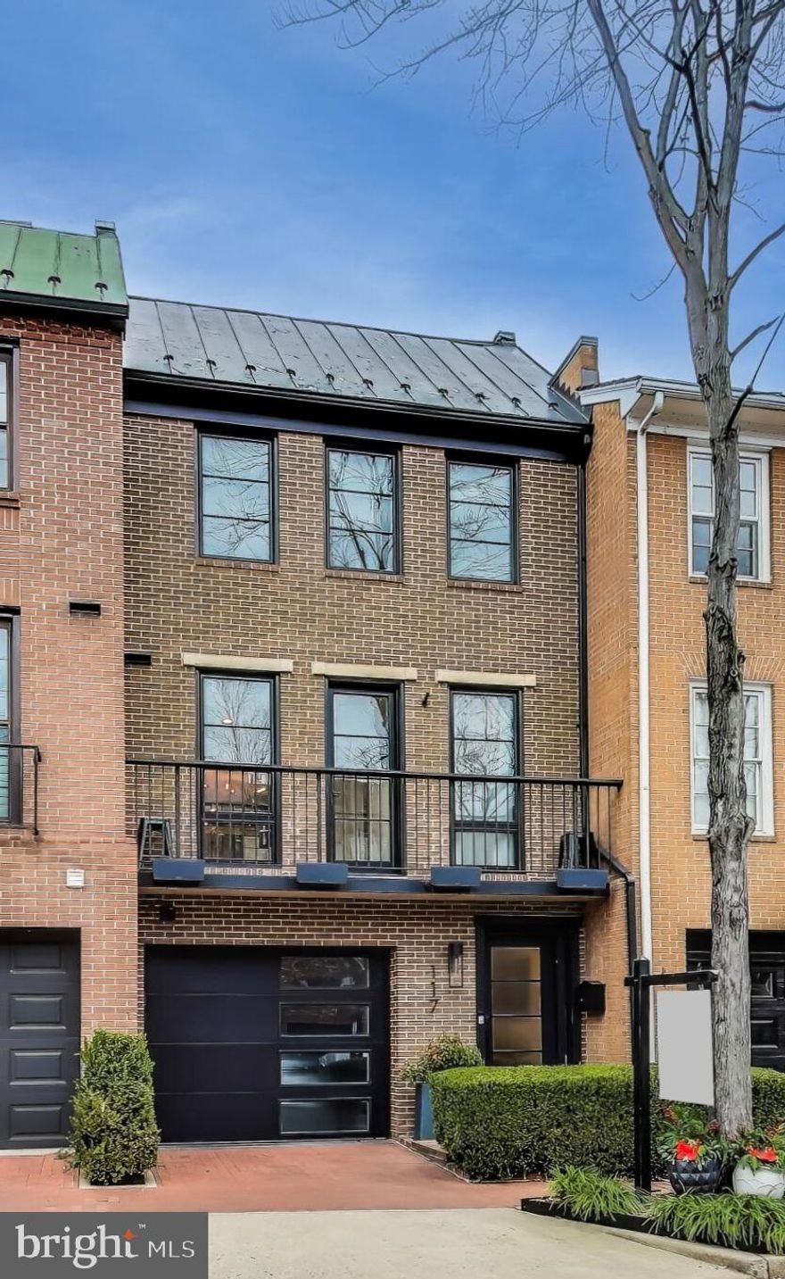 Upscale townhome just 2.5 blocks to King Street coming soon in the heart of historic Old Town Alexandria! Perfectly positioned less than one block from the lively waterfront, this meticulously renovated three-level home blends midcentury modern design with sophisticated elegance for the epitome of luxury living. On the main level of the home, you’ll discover a welcoming, open concept layout ideal for entertaining friends and colleagues! Gleaming hardwood floors lead you into the sunken light-filled living room, which boasts a stunning high ceiling and a dramatic gas fireplace flanked by built-in floating shelves. The separate dining room is perfect for intimate meals or hosting dinner parties, with a contemporary lighting fixture and convenient pass-through to the chef-inspired kitchen. On the back of the home, this gorgeously renovated gourmet kitchen is the picture of modern elegance with sleek granite countertops, a classic tile backsplash, and stainless steel appliances, including a high-end Sub-Zero refrigerator. Traveling upstairs to the third level, you’ll find your peaceful primary bedroom retreat, complete with multiple wide closets and a ceiling fan. The handsome en suite bathroom features a long vanity with an abundance of cabinet storage and an oversized-step in shower with built-in seat. With huge windows, a brick facade, and hallway access to the ultra modern second bathroom, the second sizable bedroom could be a perfect home office or guest space. Downstairs in the lower level, the third bedroom includes a Peloton bike and mirrored walls for  the ultimate private home gym experience, plus a space-saving Murphy bed. From the kitchen, step onto your wide Juliet balcony to enjoy your morning coffee or a breath of fresh air! Or, venture through the French doors for al fresco dining and entertaining on your stunning stone patio in your private fenced backyard. On the front of the home, you’ll have an attached garage and an abundance of street parking available, but there’s no need to drive anywhere from this convenient spot!  Founders Park, the Potomac River, and the Mount Vernon Trail are just outside your doorstep, with Trader Joes, Balducci’s, Safeway, Old Town Alexandria Waterfront and Harbor, and Torpedo Factory Art Center all less than a mile away. You’ll love being just minutes to popular restaurants like Vola’s, Virtue Feed & Grain, Momo Sushi Cafe, Misha’s Coffee, Tatte, plus local boutiques, Potomac Yard, and Fashion Center at Pentagon City! Quick access to King Street, Duke Street, Henry Street, Braddock Road, Rte 1, I-495, I-395, and GW Parkway. Commute effortlessly with the King Street Metro Station only 2.5 blocks away, or take the Dash bus to the Potomac Yard Metro Station for more flexibility. Don’t miss out on this opportunity to elevate your lifestyle!