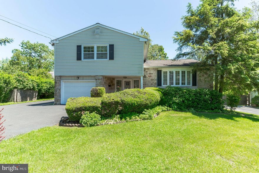 AMAZING PRICE REDUCTION - owners need to relocate out of state.  If you like open and airy, bright and cheery living, then come visit this 4 bedroom 2 1/2 bath tri-level home located in a very friendly Dresher community and in one of the top rated school districts (Upper Dublin) just steps away from the elementary school and a tot lot for your children to play.  This maintenance free home with replaced vinyl siding,  roof, doors, and  windows plus a wonderful large casement bay window in the living room.  The covered front porch is a great spot to meet your guests and lead them into the impressive ceramic tile foyer with entrance closet and powder room.  Other great features of this home include hardwood flooring in most rooms under carpeting, a very spacious living room with recessed lights, open to dining room a great place to spread out and enjoy family get togethers.  The newer kitchen has tile floors, granite counters, tile backsplash, double sink, stainless steel appliances, and gas cooking adjacent to a multi-purpose room presently used as a large pantry with built-in cabinetry - could be used as a home office or mud room.  Newer upgrades are;  HVAC system, hot water heater, shed with electricity, garage door. This home has ample ceiling fans, security system  and a finished basement with built in cabinetry, a storage room/laundry room, folding table, and exit to the yard.  Off from the main foyer is the family room whick has custom built-in cabinetry and  new sliding glass door leads you  out to a unique tile patio - a great place to enjoy morning coffee and BBQ.   Enjoy the peaceful private backyard with lush landscaping and has a large storage shed.   The driveway was expanded for 4 cars plus off street parking.  There are 4 good sized bedrooms and 2 refurbished baths.  There is a floored attic/great storage, freshly painted garage and new garage door finishes off this lovely home. This home has approximately 2400+ sq ft of living space which includes the lower level.