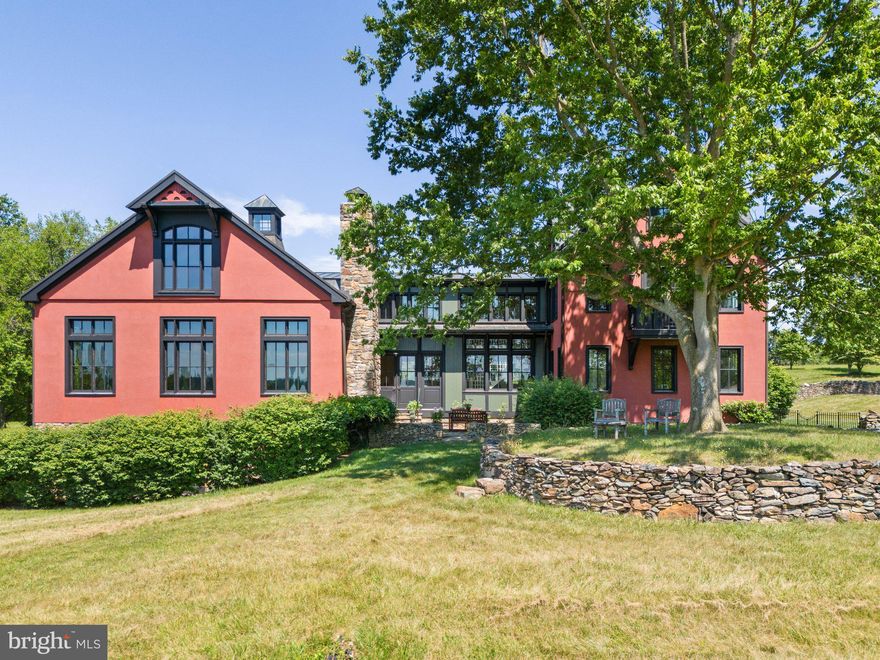 Sited high overlooking its 122 rolling acres, this impressive home features high ceilings, large windows, and spectacular views from all the main rooms. With over 7,300 sq. ft. of beautiful living space, the interior seamlessly blends rustic with elegance. 
The owners commissioned Architect Tim Clites, and Contractor Chris Carey to design, engineer and carry out the project.  The house was masterly completed in August 2004 with new foundations, systems and materials with exception of a vintage post & beam timber structure relocated from Vermont. 
A light filled front hall beautifully connects the two sections of the home. The three-level section to the southwest is the classic post & beam structure which provides grand living areas.  The structure’s hand-hewn beams were originally numbered, dismantled in Vermont and reconstructed on a stone foundation measuring 49’ x 32’.  The northeast section has four levels, which house four of the five bedrooms. Beautiful stonework, divided light windows and copper roofing tie the architecture together perfectly across the two sections.
As one enters the home, the materials and attention to detail are evident. Throughout the main and upper level is handsome random width oak flooring, milled locally. The lowest level flooring is a combination of limestone and wool carpeting. Gaston and Wyatt in Charlottesville provided the fine millwork and cabinetry throughout the house, the soapstone kitchen countertops also came from Charlottesville. Most of the high-end plumbing fixtures are from Water Works and Barber Wilson. The windows are double-paned Kolbe & Kolbe French casements with large panes framed by beautiful molding. Ceilings are varied and include vaulted with rustic exposed beams, as well as a beautifully finished mahogany coffered ceiling in the dining room. The stunning home has large windows, and French doors throughout with balconies, porches and terraces on three levels.There are gorgeous views in all directions.
Located within the Piedmont Hunt Territory, this estate offers two charming barns. One center aisle with two large stalls and attached paddocks, the other with a tack room, feed room and two oversized wash stalls. There are an additional five run-in stalls each with attached paddocks,  a riding arena (100’ x 200’), miles of trails on the farm and potential ride out beyond. 
The park-like rolling hills of Heartland’s 122 acres enjoy a beautiful southern exposure and a nice mix of cleared and wooded land with over eight miles of well-maintained trails and two tributaries of Goose Creek. Elevations range between 420’-550’ with the land sloping down towards Goose Creek. This property shares its southern boundary with the B-Line of the Norfolk-Southern. It is currently enrolled in the Upperville Agricultural District until 2029 offering excellent land use flexibility. 
Heartland’s location is ideal providing tremendous privacy while being just minutes from the historic villages of Middleburg and Upperville. Being in Delaplane, one has easy access to I-66 with Washington, D.C. to the east and the Shenandoah Valley to the west. Truly an exceptional combination of home, land, and location!