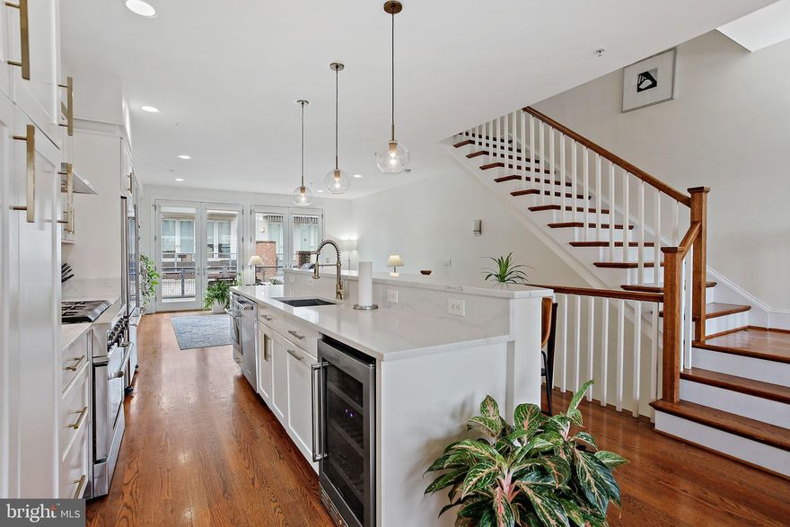 Welcome to 1324 Haubert Street. A four-story townhome set in the heart of Locust Point, where city energy meets waterfront living. Light pours in from every level. Storage stays abundant. Garage parking keeps life simple. A rooftop deck seals the deal.

The entry level sets the tone. The first of three bedrooms sits on the first floor, finished with custom paint and a built-in Murphy bed. It works as a guest suite, home office, or flex space without compromise. Fresh paint and hardwood floors run throughout. A full bath and utility room add everyday function, with a newly updated HVAC system, water heater, and hardware giving peace of mind. Direct access to the enclosed two-car garage delivers rare city convenience, plus extra storage and a second refrigerator. 

Up one level, the home opens wide. The living room feels bright and expansive, anchored by high ceilings and hardwood floors. Custom built-ins and an entertainment center elevate the room while keeping it practical. Dual French doors flood the space with natural light and lead to a private outdoor deck. Brand New Composite materials and weatherproof details make for a maintenance-free, long-lasting, outdoor retreat - Perfect for morning coffee, evening wine, or hosting friends.

The kitchen commands attention. An oversized island invites gathering. Sparkling new quartz crystal countertops, custom built-in cabinetry, and a JennAir gas range deliver a true chef’s setup. Stainless steel appliances complete the look.

The dining area flows seamlessly, making everyday living easy and entertaining effortless. Newly updated lighting and hardware throughout elevate these spaces with timeless and modern appeal, making everything shimmer and shine. 

The third floor offers privacy and comfort. The primary suite feels like a retreat, with his and hers closets and a spa-inspired bath featuring dual vanities, a soaking tub, and a walk-in shower. French doors bring in natural light and open to a private balcony made with the same brand new long-lasting materials guarantee many peaceful city views. A second bedroom on this level features hardwood floors, a large walk-in closet, and oversized windows for an open, airy feel. The top floor brings the lifestyle home. 

A loft with an updated wet bar opens to an expansive rooftop deck. City skyline. Water views. Sunset evenings. This space turns ordinary nights into something special and makes entertaining unforgettable. 

Locust Point ties it all together. Walkable streets. Waterfront paths. Easy access to the free water taxi to Fells Point. Close to downtown, I-95, and major transit. You stay connected without giving up neighborhood charm. 1324 Haubert Street delivers light, space, storage, and views. Homes like this do not come around often. Come see it. Picture your life here.