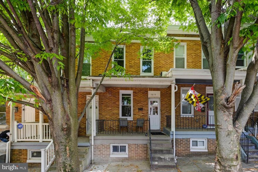 BEST AND FINAL DUE THURSDAY 5/25 at 9pm. Charming porch front townhome located on treelined street in Woodberry. Just minutes away from Hampden- shopping, dining and entertainment and seconds away from gorgeous parks and trails- Druid Hill Park, Jones Falls Trail, Wyman Park, Stoney Run Walking Path, The Zen Garden and many more. Open main level, family room with wood floors, kitchen with island and updated appliances that opens to rear yard with patio. Two generous sized bedrooms and one full bath. Finished lower level- perfect for office or recreation room.Parking spaces along the back of the home and street parking make for easy parking! Sellers prefer to sell the home As-Is.