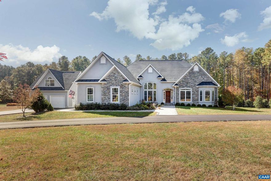 Dreams are made at this custom home at Lake Anna! In The Waters with a deeded boat slip, club house, tennis courts and more! Here you'll find this his beautiful 3 bed/2 bath home set on 5 acres, with upgrades galore! With an oversized kitchen with granite counters and custom cabinets, large open living room, raised ceilings, separate dining room, wood floors, huge master with on suite bathroom, dog wash, attached garage, and detached SECOND garage with a finished 4th room above. Loads of storage above the garage, then outdoors there is a fenced in yard, trex decking, gardening area with raised beds, in-ground pool, covered back porch, custom landscaping and hardscape-this truly is a dream come true.