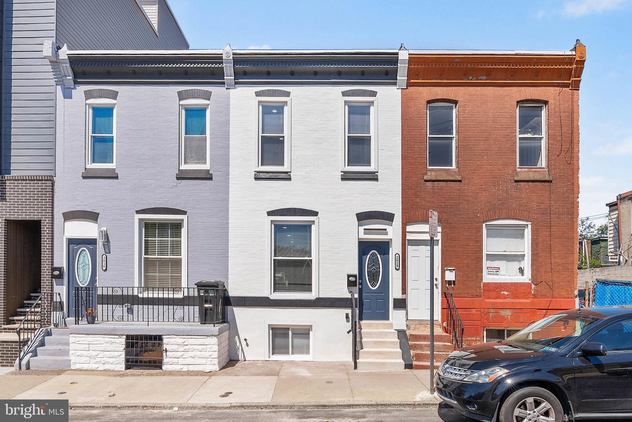 Expertly rehabbed with meticulous attention to detail, 2618 N 7th St is a large, luxurious 2-story home offering 3 bedrooms, 3 full and 1 half bathrooms, a finished basement, a private backyard, and a high-end design throughout. Out front, you're welcomed by a freshly painted white brick facade and a vibrant blue door. Inside, the main level has a bright, open, and airy feel, aided by high ceilings and modern floors. There's plenty of space for hanging out around the fireplace in the living room or entertaining friends and family in the dining area. The highlight of the home is surely the showstopping kitchen fitted with unique waterfall white counters accented by gold veining that matches the fireplace, a coordinating backsplash, 42" white shaker cabinetry, stainless steel appliances, and bar seating. Completing this level is a laundry room and a powder room. Out back, the large, private patio acts as an escape from the city's hustle, where you can spend your summer nights barbecuing and dining under the stars. More living space is found in the finished basement, along with a full bathroom, perfect for a home theater, play room, gym, or guests. Up on the second level, the spacious, sunlit primary bedroom at the front has lots of closet space. Down the hall, two more bright bedrooms flank a pair of sleek full bathrooms adorned with luxurious tile and fixtures. 2618 N 7th St's utilities include central a/c, gas heat, and electric hot water. This prime location, off of Lehigh Ave, is a short walk from restaurants, markets, and stores. Parks and rec centers are close, plus Temple University is less than 10 minutes away. There's also easy access to public transit, Broad St, and Germantown Ave. Schedule your tour today!