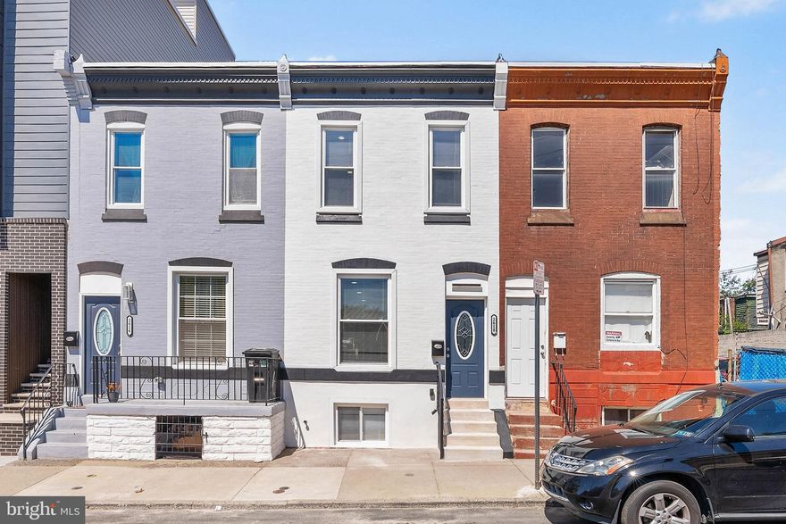 Expertly rehabbed with meticulous attention to detail, 2618 N 7th St is a large, luxurious 2-story home offering 3 bedrooms, 3 full and 1 half bathrooms, a finished basement, a private backyard, and a high-end design throughout. Out front, you're welcomed by a freshly painted white brick facade and a vibrant blue door. Inside, the main level has a bright, open, and airy feel, aided by high ceilings and modern floors. There's plenty of space for hanging out around the fireplace in the living room or entertaining friends and family in the dining area. The highlight of the home is surely the showstopping kitchen fitted with unique waterfall white counters accented by gold veining that matches the fireplace, a coordinating backsplash, 42" white shaker cabinetry, stainless steel appliances, and bar seating. Completing this level is a laundry room and a powder room. Out back, the large, private patio acts as an escape from the city's hustle, where you can spend your summer nights barbecuing and dining under the stars. More living space is found in the finished basement, along with a full bathroom, perfect for a home theater, play room, gym, or guests. Up on the second level, the spacious, sunlit primary bedroom at the front has lots of closet space. Down the hall, two more bright bedrooms flank a pair of sleek full bathrooms adorned with luxurious tile and fixtures. 2618 N 7th St's utilities include central a/c, gas heat, and electric hot water. This prime location, off of Lehigh Ave, is a short walk from restaurants, markets, and stores. Parks and rec centers are close, plus Temple University is less than 10 minutes away. There's also easy access to public transit, Broad St, and Germantown Ave. Schedule your tour today!