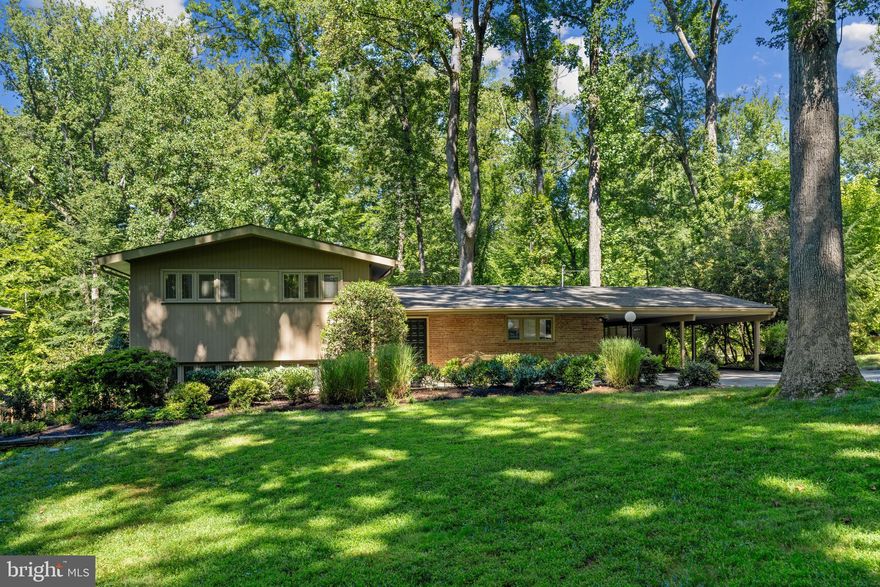 Stunning mid-century modern home situated on a beautiful .65 acre lot located in the highly sought-after Bradley Hills neighborhood of Bethesda.  This spacious 6 bedroom 4 full bath split-level has walls of windows boasting abundant sunlight.  Upon entering the foyer of this 4-level home you are greeted with slate floors connecting to a magnificent  living area and a formal dining room. This open and bright dining and living room space has a wood burning fireplace and high ceilings overlooking a serene and private tree-lined backyard. From the dining room enter though french doors to a screened-in porch with slate floors and skylights great for entertaining.  Continuing on the main level is an expansive and updated eat-in kitchen featuring  brand new stainless steel appliances, quartz countertops, and new luxury vinyl tile floors.  The kitchen skylights allow plenty of sunlight to stream in.  The upper level includes 3 large bedrooms and 2 full baths.   The primary bedroom has an en-suite bathroom and a balcony with beautiful views of the backyard.  The original oak hardwood floors on the main and upper levels have been completely restored to their natural finish. 
The lower level has a large family room, a gas fireplace, and wall to wall windows overlooking one of the two backyard flagstone patios. Next to the family room are the 4th and 5th bedrooms and a full bathroom.   Use either bedroom as a guest room, in-law-suite, or home office.  The large basement includes a laundry room and has a generous amount of space for an exercise and/or game room.   As an added bonus,  the basement also has a 6th bedroom with an updated full bathroom and has windows facing the spacious backyard.  Many NEW updates including: Stainless steel kitchen appliances 2023,  quartz kitchen countertops 2023, refinished main & upper-level hardwood floors 2023, LED recessed lights & Decora light switches throughout 2023, relined two fireplaces 2023, electric panel 2023,  dryer 2023, roof 2020 (lower) and 2021 (upper), two kitchen skylights 2023, luxury vinyl plank throughout the lower level and basement 2023, two-zoned HVACs 2014 & two gas hot water heaters 2014. The large backyard provides ample opportunity to expand the home and to build a pool. Award winning schools: Burning Tree ES, Pyle MS & Walt Whitman HS. Centrally located inside the Beltway with easy access to I495 and minutes to downtown Bethesda, DC and Northern Virginia  This move-in ready home is waiting for its 2nd owner.  The seller is a licensed Realtor.   A Must See!