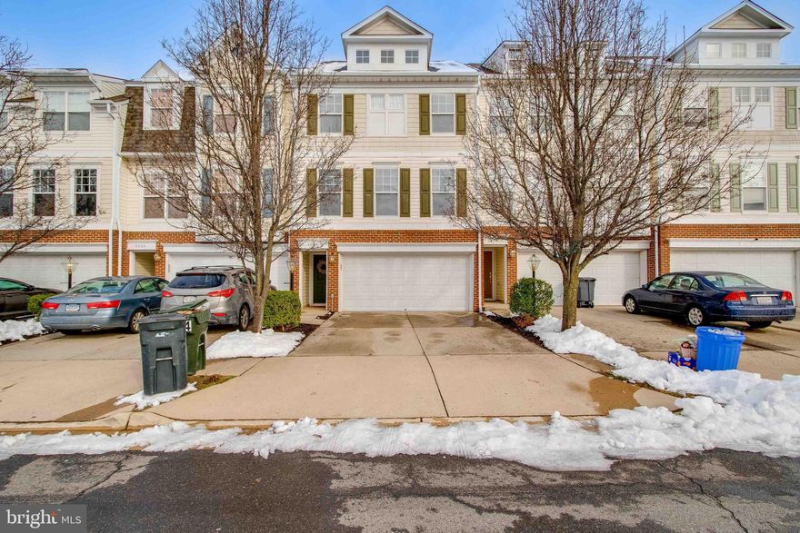 Welcome home to this bright and spacious 3 bedroom, 3.5 bath townhome in Blooms Mill with 2,478 sq ft of space. Just minutes away from the VRE and RT 28 make it a commuters dream location! Walk up the carpeted steps to the main level with an open floor plan - perfect for entertaining friends and family! The living room features plush carpeting, crown molding, wainscoting, and recessed lighting. Spacious kitchen features hardwood floors, rows of recessed lighting, plenty of cabinet space, island with bar seating, and large double sink with detachable faucet and window view. Also features a closet pantry, plus all stainless steel appliances including a triple door fridge with ice maker. Entertain guests easily in the neighboring dining room with a great view through the sliding glass doors. Take a break on your brand new, upper-level, open-air Trex deck - the perfect place for a backyard BBQ! Half bath completes the level. Unwind in your main bedroom suite on the upper level that features a double door entrance and plush carpeting. Enjoy the light and airy feel that the vaulted ceiling and cooling ceiling fan give! Also features a spacious walk-in closet and an en-suite newly-remodeled bathroom with dual sink vanity and stall shower. Two bedrooms, a hall bath, and a laundry closet full-size washer and dryer complete the level. The entry/ground level is perfect for an additional living area, rec room, or office space. Features a convenient coat closet, full-size bathroom, and brand new laminate flooring that flow throughout. The lower-level sliding glass door leads outside to the fully fenced-in backyard and patio. Plenty of room for parking with the attached two-car garage (additional space for storage), and driveway. Community center and pool just one block away. Tot lot across the street, plus plenty of open on-street parking. Close to shopping and the Manassas historic district. Do not miss out on this one!