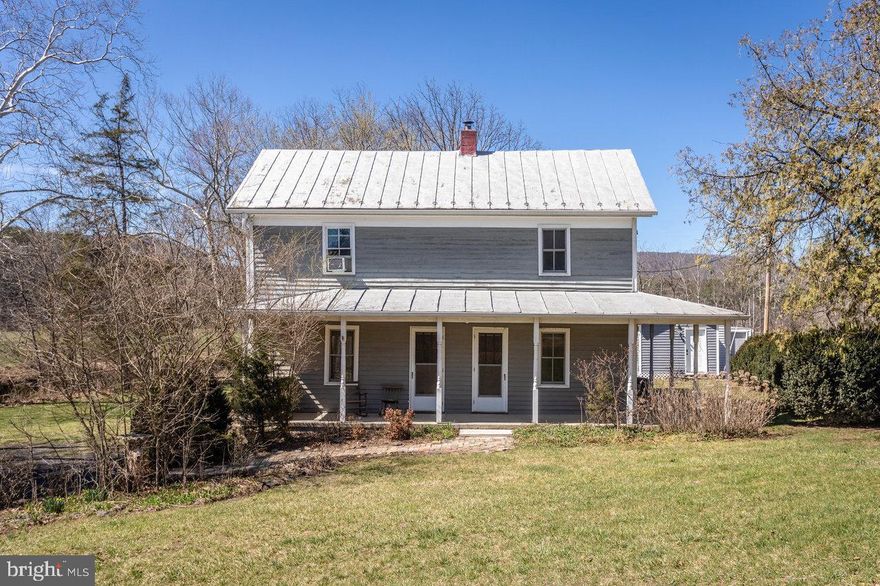 Nestled along the serene Passage Creek in Fort Valley, Virginia, 2435 Seven Fountains Road presents a unique blend of historic charm and modern comfort in this antique log home with a Tiny House.  Great for Investors with AIRBNB potential abounds! The property extends to the lovely stream of Passage Creek, complete with a private dock with steps into the creek,  ideal for swimming, kayaking and fishing.​This PRIVATE getaway is surrounded by hundreds of acres of  farmland and mountains.  The originial log portion of the home dates to the early 19th century, with the remainder of the home constructed in 1896, this meticulously restored farmhouse boasts two bedrooms and two full bathrooms, offering a tranquil retreat from the everyday.​ The second bedroom was built as TWO bedrooms and was converted to one 20 foot long bedroom.  The third bedroom could easily be added from the larger bedroom.  The main house could easily sleep 8 guests with 3 more guests in the Tiny House for a total of approximately 11 guests.  New closets and shelving throughout.  New water treatment system recently installed.  Upstairs windows and bath are all new.     Most of the beautiful furnishings and antiques will convey.  

The home's interior showcases exposed log walls, preserving its historical character while providing a warm and inviting atmosphere. The new kitchen features modern amenities and finishes, making it both functional and stylish.​

Step outside to find a spacious wrap-around porch, perfect for relaxing and taking in the picturesque surrounding of mountains and farmland. 

Additionally, a detached tiny house consists of a kitchenette with a half bath and offers versatile space for visitors, a home office, or creative pursuits.  Pull out queen sleeper sofa with a single bed for added guest in the tiny house.   Situated on a 1.01-acre lot, this property provides a peaceful and private setting, all within a convenient drive from local amenities and attractions