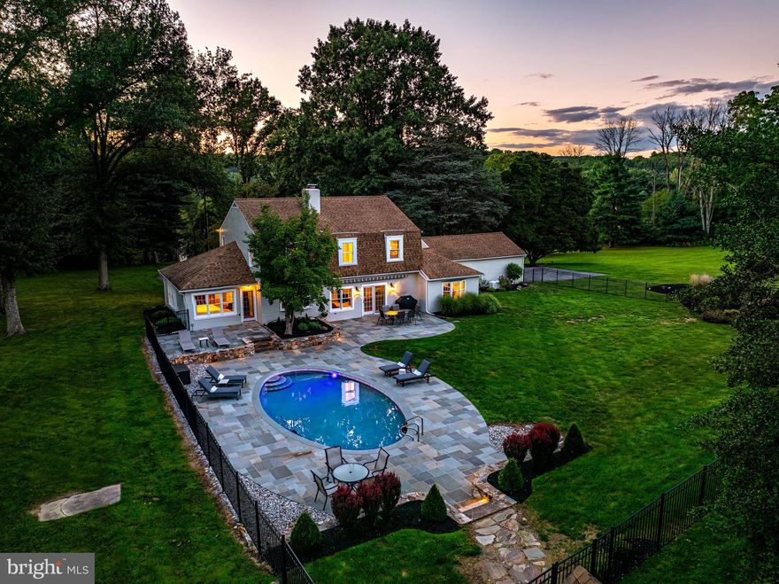 Imagine stepping into your own private sanctuary, set against the breathtaking backdrop of Chester County. This meticulously renovated, turn-key home is more than just a place to live—it's a lifestyle, a retreat, and a dream come true. Nestled on a sprawling 9-acre estate, complete with a circular driveway and an inviting in-ground pool, this property offers a level of privacy and serenity that few can imagine, let alone experience. As you approach, the charm of this home is undeniable. The antique front doors, carefully restored to their former glory, swing open to reveal an interior that exudes both grandeur and warmth. The moment you step inside, you're welcomed by the rich texture of custom woodwork, from the wide-plank oak flooring which flows through the entire home to the 7" baseboards and the intricate crown molding that adorns each room. The sun-drenched foyer introduces an open, flowing floor plan that seamlessly blends comfort with elegance, making it an entertainer’s paradise. The living room is a masterpiece of design and comfort, featuring a cozy wood-burning fireplace, a built-in butler’s bar, and patio french doors that lead you directly to your personal outdoor oasis. Adjacent to this space is the kitchen of your dreams—a fully renovated, magazine-worthy culinary haven. Outfitted with high-end stainless steel appliances, solid maple cabinetry, under-cabinet lighting, and gleaming granite countertops, this kitchen is as functional as it is beautiful. The spacious dining area, which is open to the kitchen, offers panoramic backyard views as your backdrop. The first floor also includes a versatile office or family room with built-in shelving, wood stove, and abundant character, as well as a luxurious primary suite. This tranquil retreat features a bay window with picturesque pool views, an outside walkout, a full bath with both a stall shower and bathtub, and closets that will satisfy even the most discerning fashionista. A charming turned wooden staircase leads you to the second floor, where you'll find two more generously sized bedrooms connected by a Jack-and-Jill bath, and an additional bedroom suite with its own private bath. But the magic doesn't stop inside. Step outside onto the expansive 2,000 sq. ft. Bluestone patio, complete with a Sunsetter awning, and take in the serene views of your saltwater pool and the rolling 9-acre landscape. This property offers endless possibilities, whether you're hosting family picnics, barbecues, or simply savoring a quiet morning coffee while watching deer graze in the meadow. Every detail has been considered to ensure that this home is not only beautiful but incredibly functional, with features like Pella windows, a replacement electrical panel, relined fireplaces, and a new water heater. Located in the highly sought-after Owen J. Roberts school district, this secluded country estate offers the perfect blend of peaceful living and convenience, just moments away from shopping, dining, and the PA Turnpike. This is more than a home; it's a place where memories are made, a retreat from the hustle and bustle of everyday life, and a dream come true for those lucky enough to call it their own.