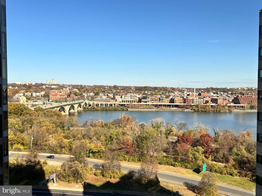 Nestled in the prestigious Rosslyn neighborhood, this exquisite one-bedroom, one den, one-bathroom apartment offers a luxurious urban lifestyle with stunning views of the Potomac River. Built in 2008, this contemporary high-rise unit combines modern elegance with comfort, making it the perfect retreat in the heart of the city. Step inside to discover an open floor plan that seamlessly integrates the kitchen and living areas, creating a warm and inviting atmosphere with floor to ceiling windows. The upgraded countertops and sleek cabinetry in the kitchen are complemented by high-end appliances, including a built-in microwave, gas oven, and a front-loading dryer, ensuring both style and functionality. The energy-efficient windows bathe the space in natural light, enhancing the beauty of the wood floors throughout. The spacious bedroom features an entry-level design, providing easy access and a cozy ambiance. The primary bath is a sanctuary of relaxation, equipped with modern fixtures and finishes that elevate your daily routine. he additional Den provides an extra space which can be used as an office or library or whatever you want. This unit is not just about the interior; it extends to a wealth of amenities that enhance your living experience. The building also features multiple elevators for easy access and reserved parking in the secure underground garage.  Step outside to the roof deck, where you can unwind with breathtaking views while grilling on the BBQ grill. The serene environment is perfect for enjoying the outdoors, whether you're hosting a gathering or simply soaking in the tranquility of the surroundings. Safety and security are paramount, with features including a main entrance lock, sprinkler system, and smoke detectors ensuring peace of mind for residents. With the Potomac River just moments away, this property offers a unique blend of luxury living and natural beauty. Experience the exclusive lifestyle that comes with residing in this remarkable community, where every detail has been thoughtfully designed for your comfort and enjoyment. Embrace the opportunity to call this stunning apartment your home, where modern elegance meets the charm of riverside living.
Residents benefit from full-service amenities including 24-hour front desk, concierge, on-site property management, a rooftop terrace with gas grills and direct views of D.C. landmarks like the Potomac River, the Washington Monument, Kennedy Center, and Lincoln Memorial., a fitness center, and access to room service and hotel amenities via Le Méridien. Located in the heart of Rosslyn, you're just moments from Georgetown, the National Mall, Reagan National Airport, and the Rosslyn Metro (Orange, Blue, and Silver lines). Enjoy a lifestyle of convenience and prestige with riverfront trails, vibrant dining, high-end retail, and cultural landmarks all within reach.